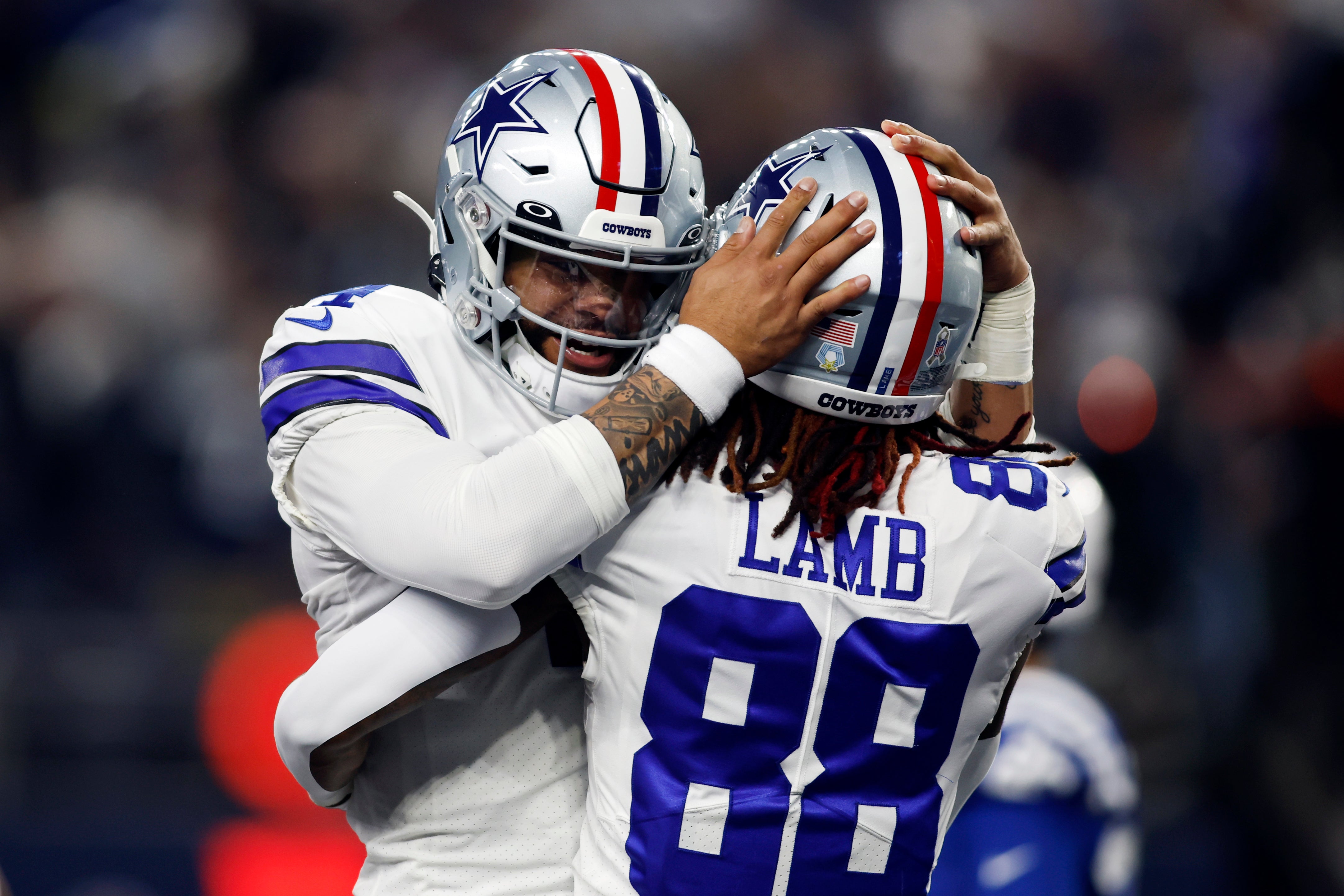 Dallas Cowboys quarterback Dak Prescott hugging WR CeeDee Lamb