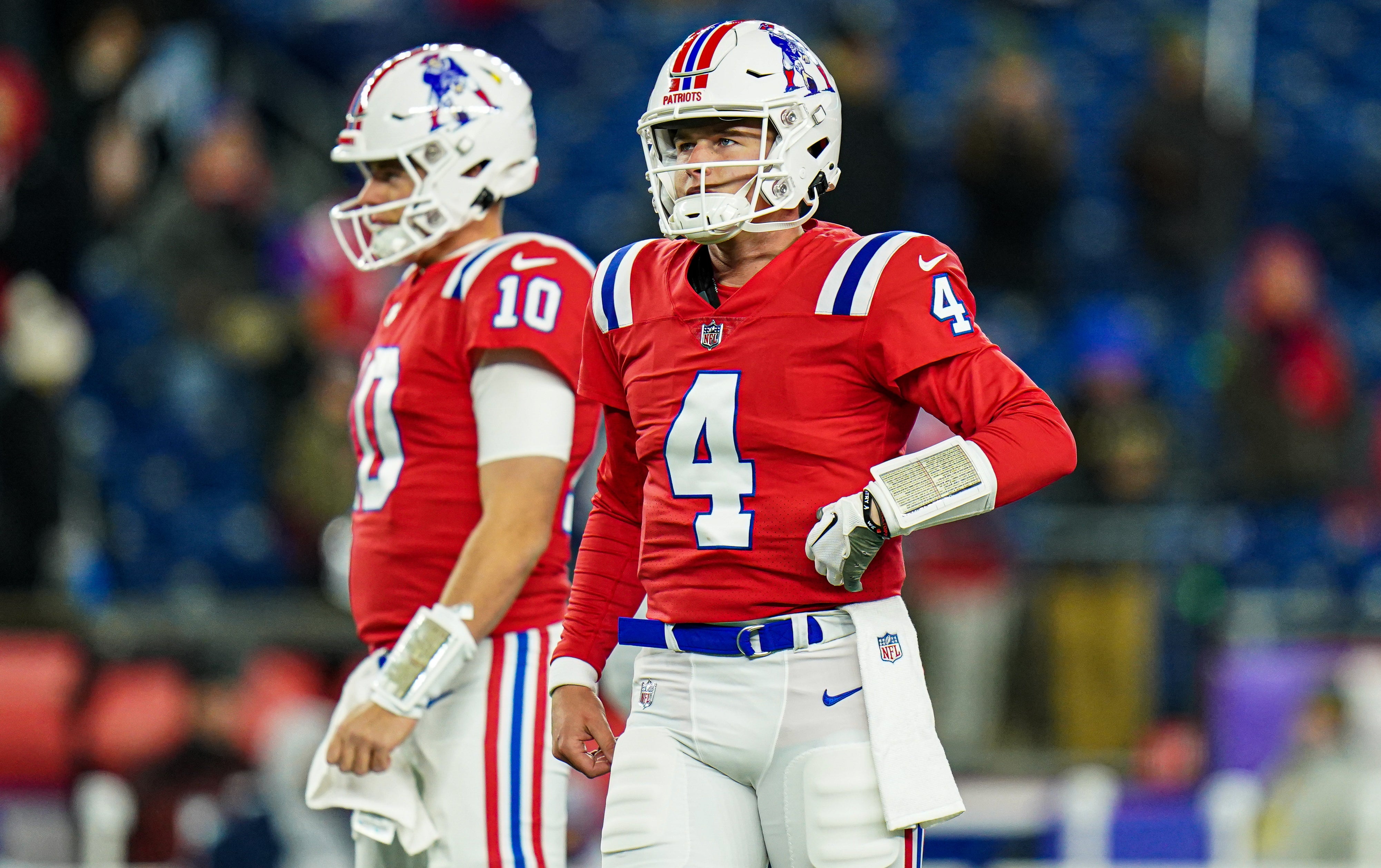 Dec 1, 2022; Foxborough, Massachusetts, USA; New England Patriots quarterback Bailey Zappe (4) and quarterback Mac Jones (10) warm up before the start of the game against the Buffalo Bills at Gillette Stadium.