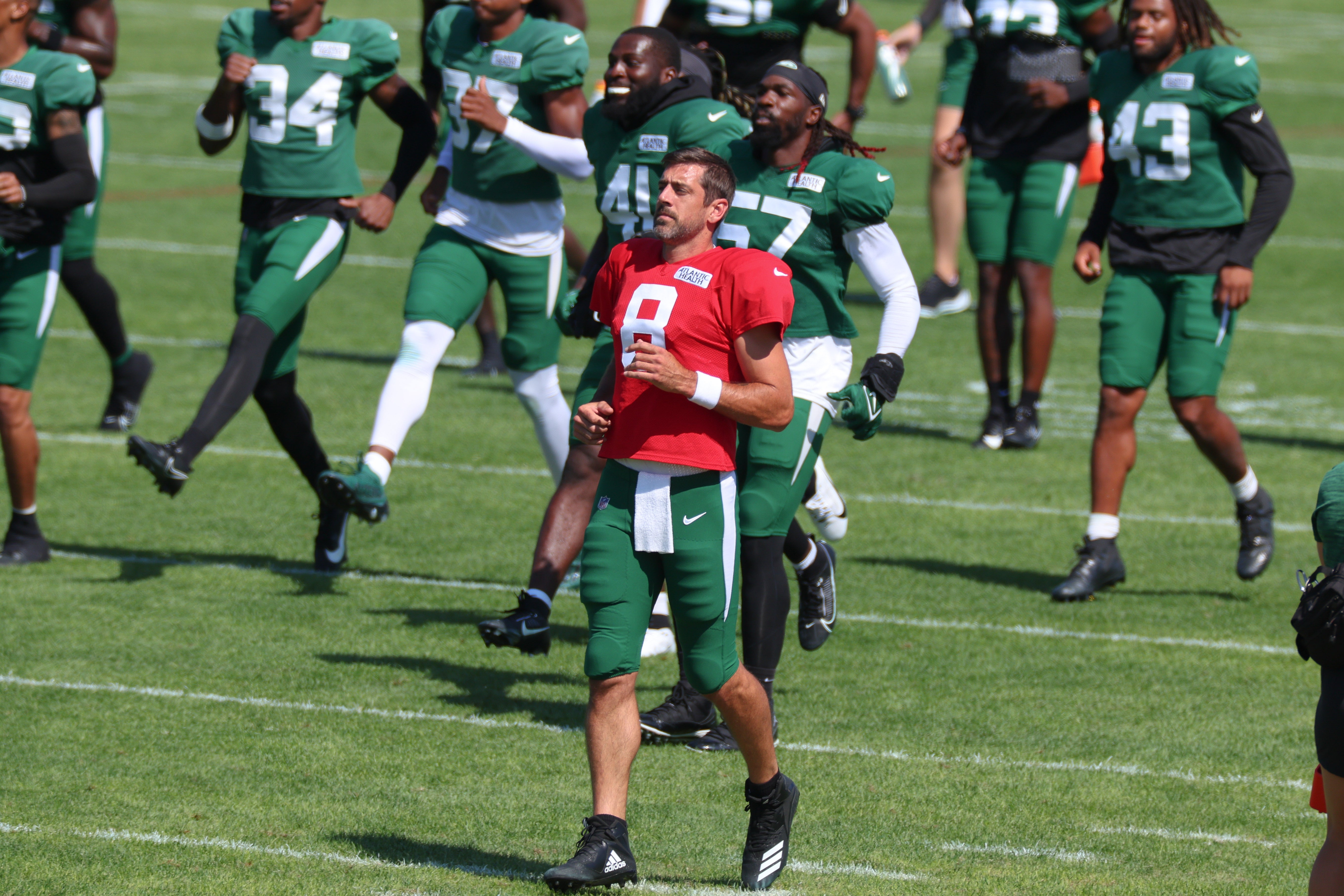 New York Jets quarterback Aaron Rodgers (8) warms up with teammates during the New York Jets Training Camp at Atlantic Health Jets Training Center.