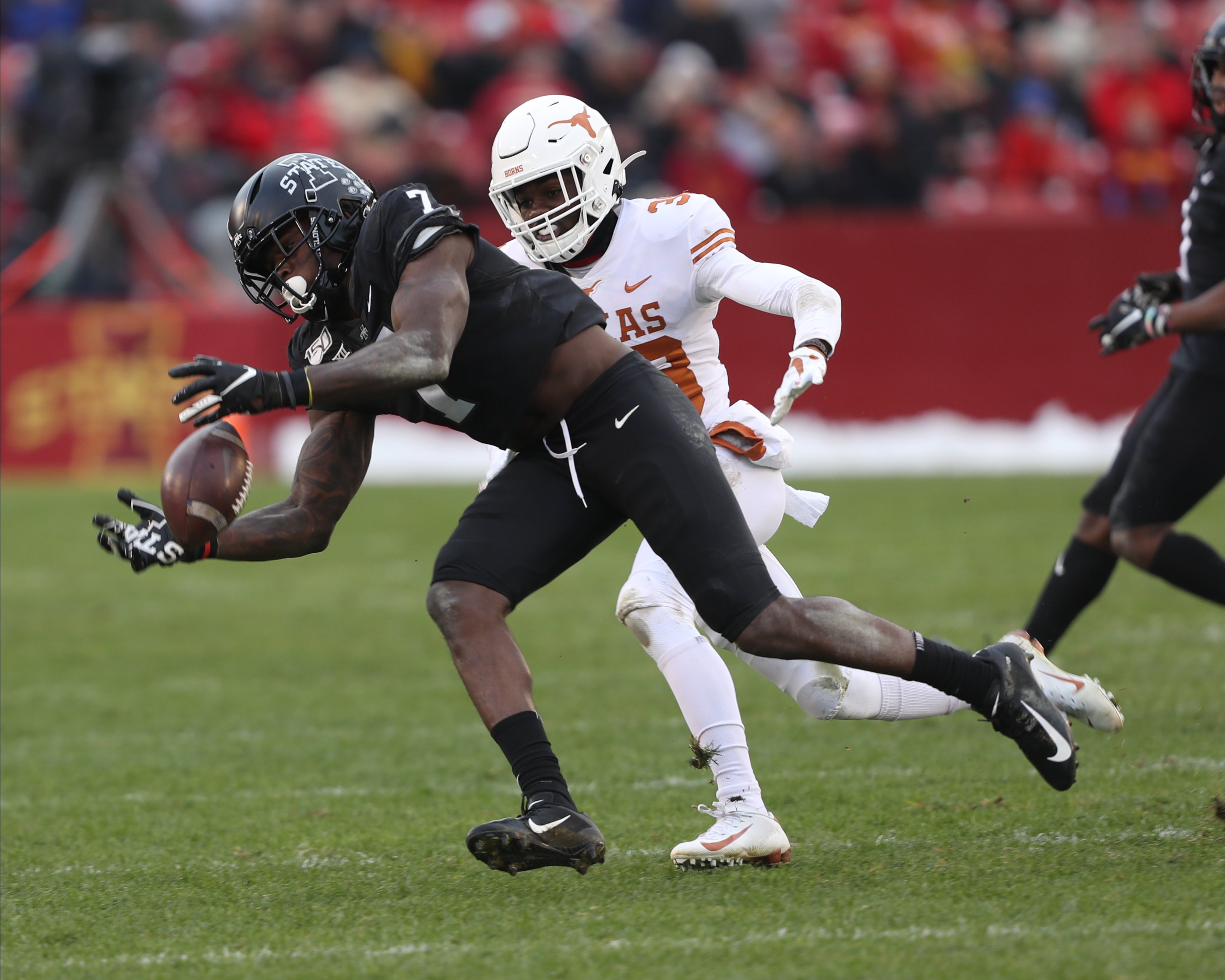 Nov 16, 2019; Ames, IA, USA; Iowa State Cyclones wide receiver La'Michael Pettway (7) catches a pas in front of Texas Longhorns linebacker David Gbenda (33) at Jack Trice Stadium. The Cyclones beat the Longhorns 23 to 21.