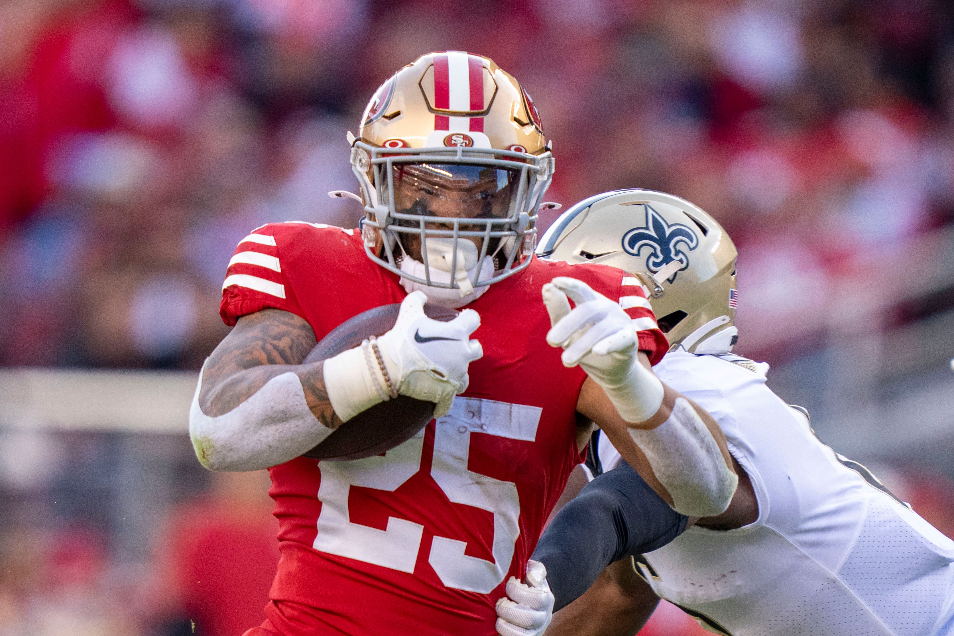 November 27, 2022; Santa Clara, California, USA; San Francisco 49ers running back Elijah Mitchell (25) runs against New Orleans Saints safety Marcus Maye (6) during the second quarter at Levi's Stadium. Mandatory Credit: Kyle Terada-USA TODAY Sports