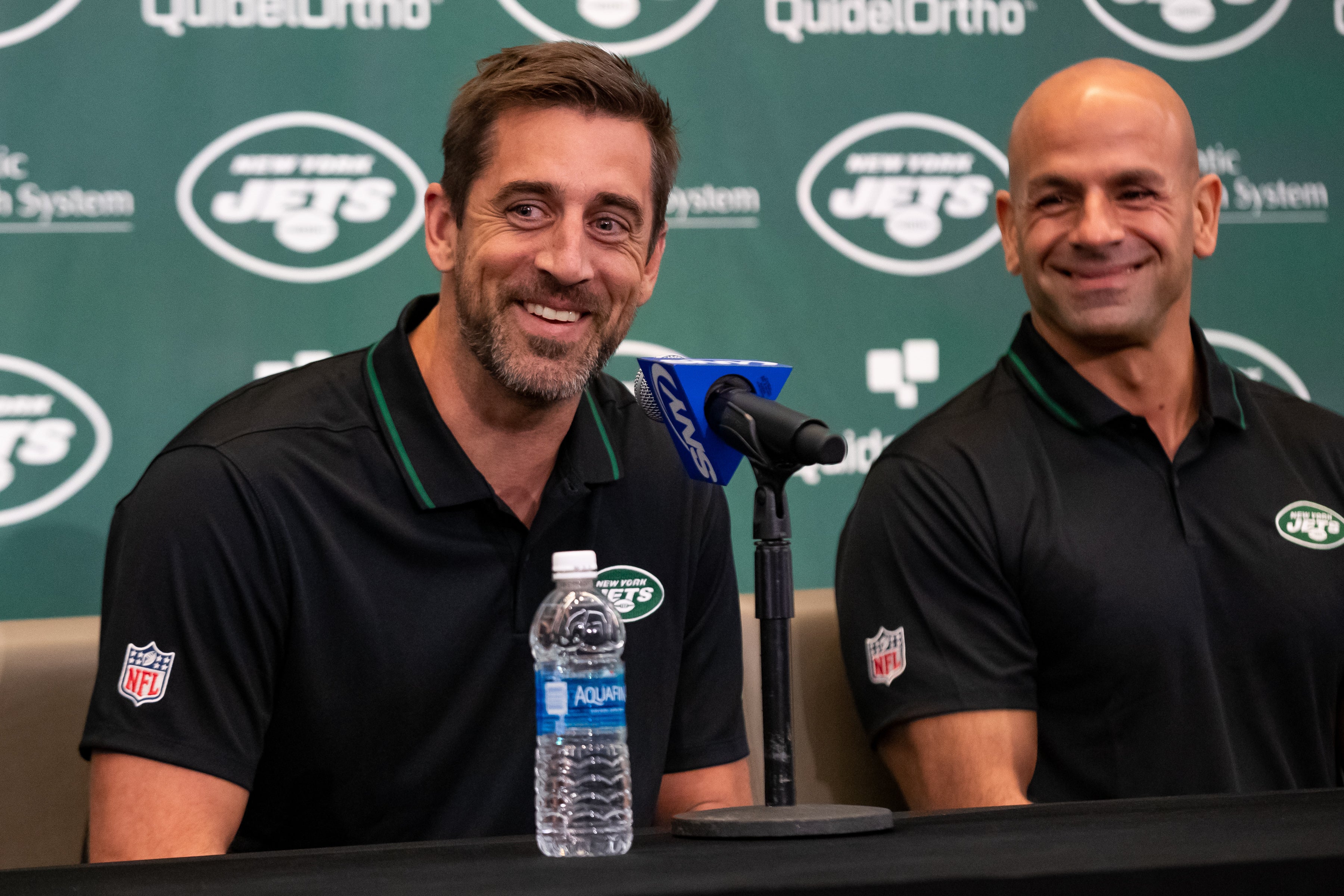 New York Jets QB Aaron Rodgers sitting next to head coach Robert Saleh