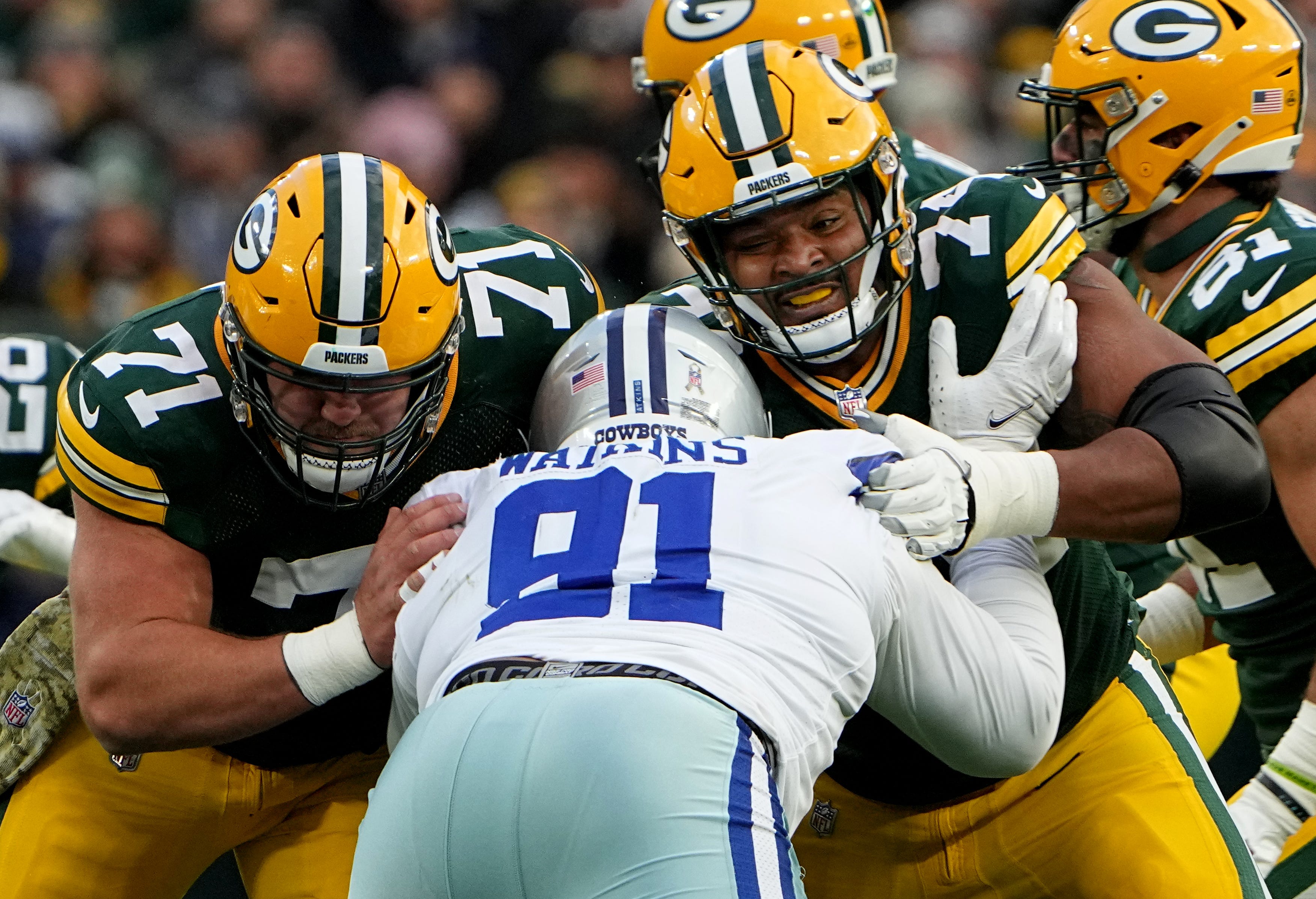 Green Bay Packers center Josh Myers (71) and guard Elgton Jenkins (74) double team Dallas Cowboys defensive end Carlos Watkins (91) during their game Sunday, November 13, 2022 at Lambeau Field in Green Bay, Wis. The Green Bay Packers beat the Dallas Cowboys 31-28 in overtime