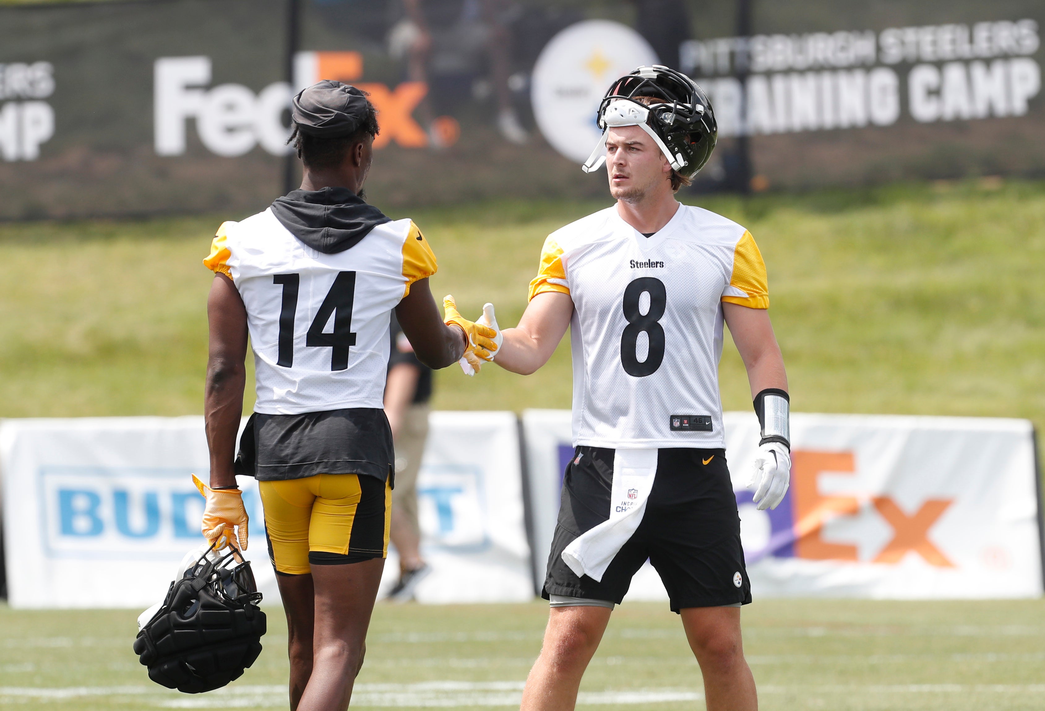 Jul 27, 2023; Latrobe, PA, USA; Pittsburgh Steelers wide receiver George Pickens (14) and quarterback Kenny Pickett (8) react between drills during training camp at Saint Vincent College.