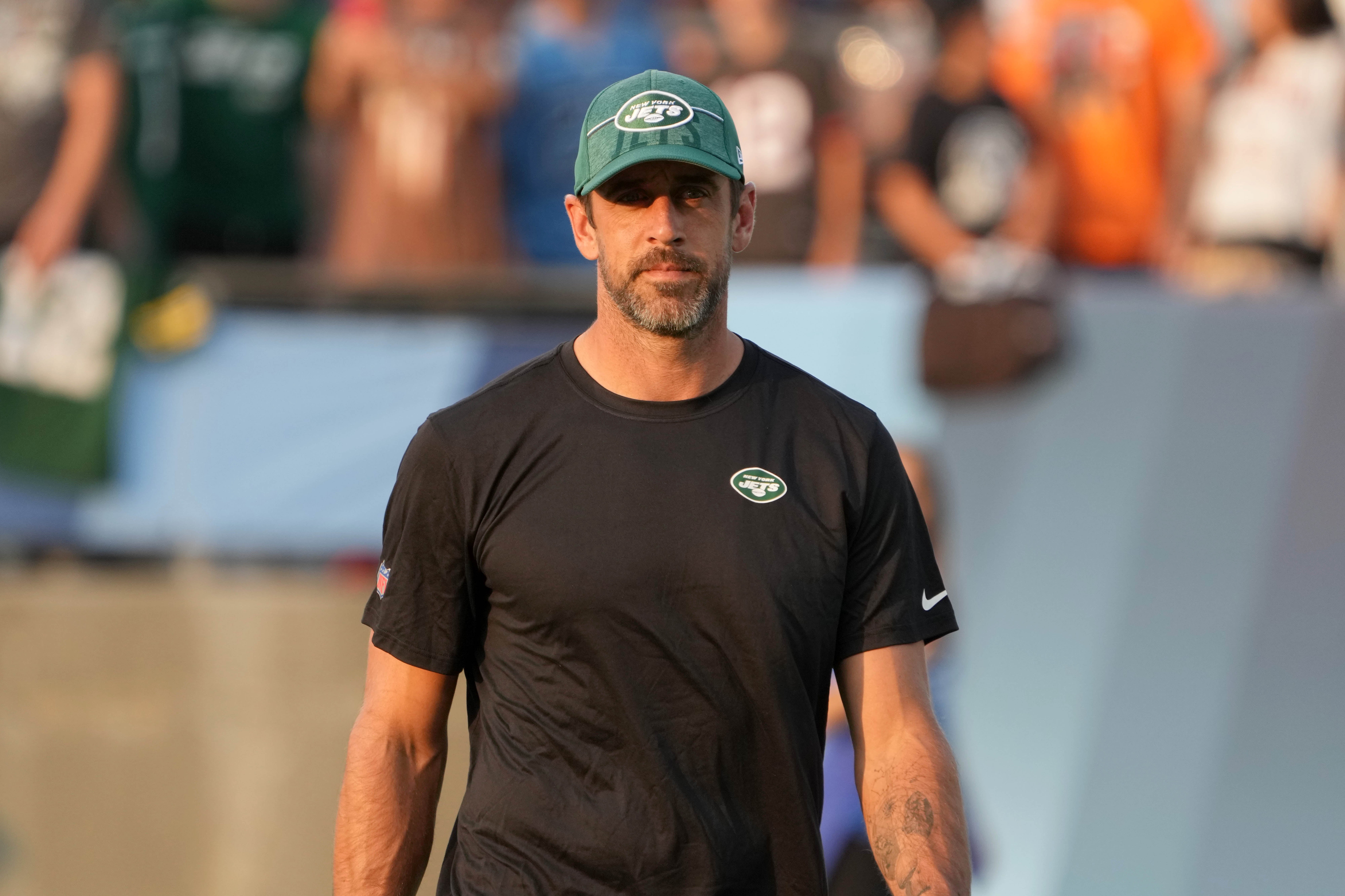 New York Jets quarterback Aaron Rodgers (8) watches from the sidelines during the first half against the Cleveland Browns at Tom Benson Hall of Fame Stadium.