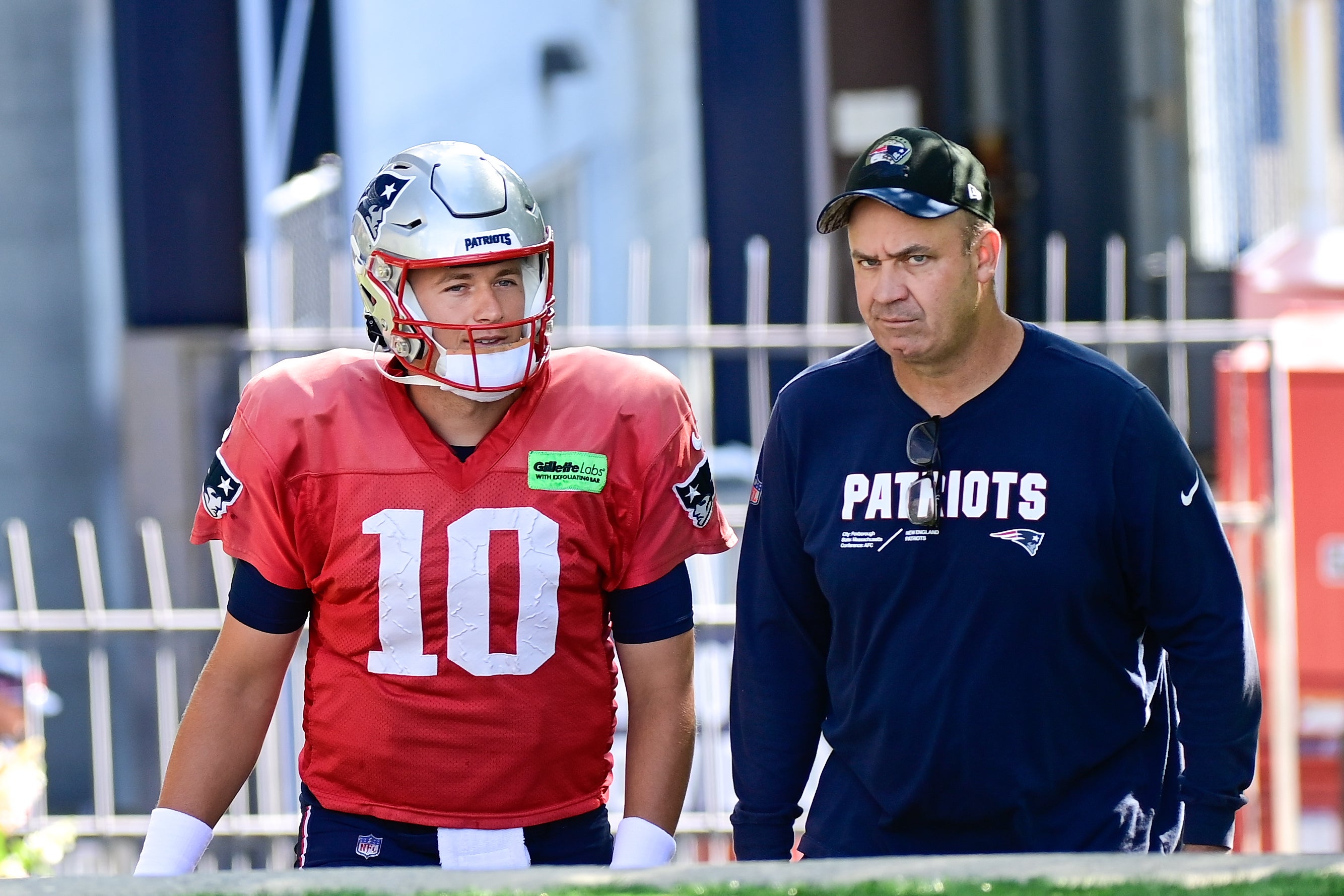 Aug 3, 2023; Foxborough, MA, USA; New England Patriots quarterback Mac Jones (10) and offensive coordinator/quarterbacks coach Bill O'Brien head to the practice fields for training camp at Gillette Stadium.