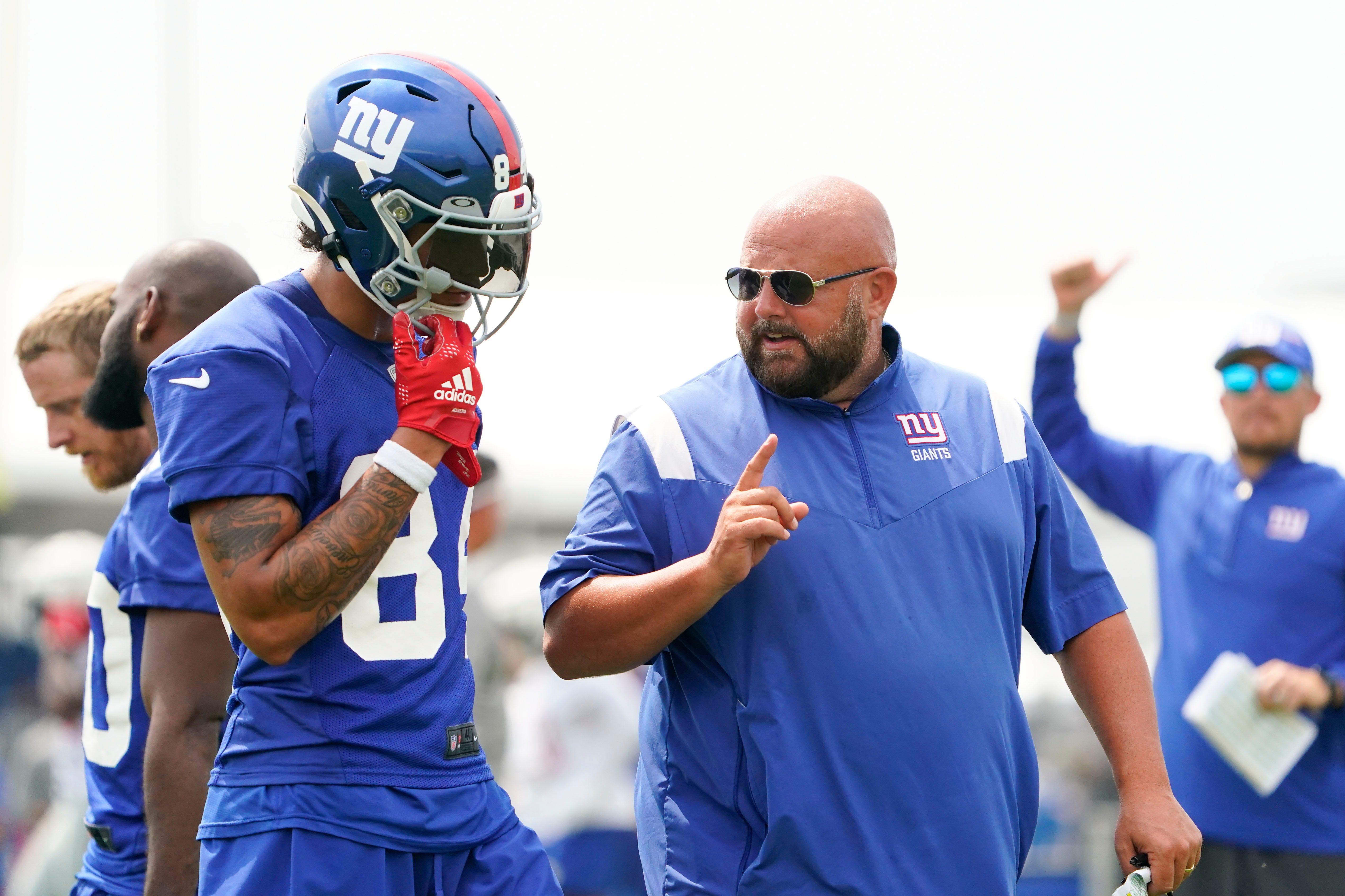 New York Giants rookie wide receiver Jalin Hyatt, left, and head coach Brian Daboll talk during training camp on July 27, 2023, in East Rutherford.