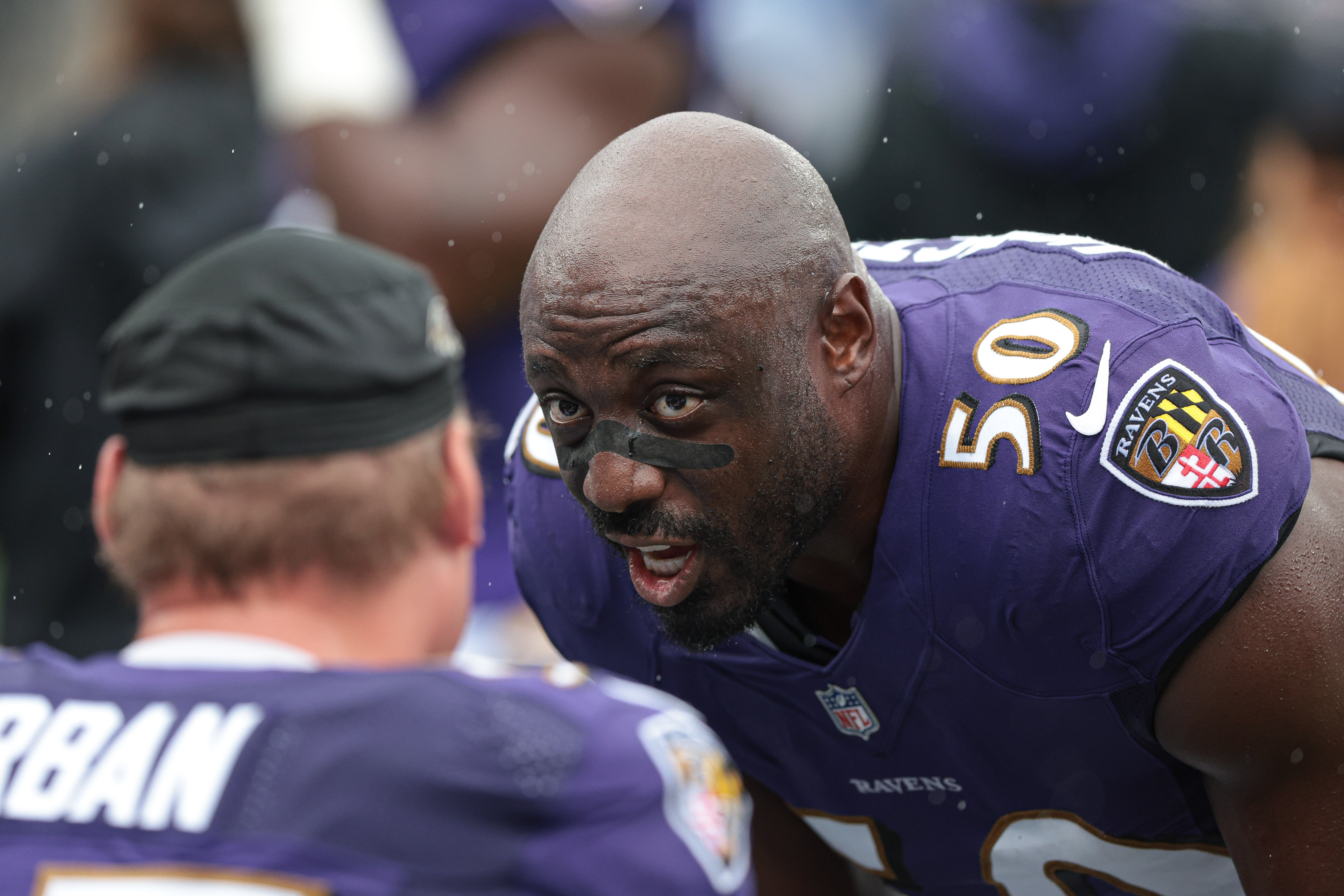 ep 11, 2022; East Rutherford, New Jersey, USA; Baltimore Ravens linebacker Justin Houston (50) talks with teammates during the first half against the New York Jets at MetLife Stadium. Mandatory Credit: Vincent Carchietta-USA TODAY Sports.
