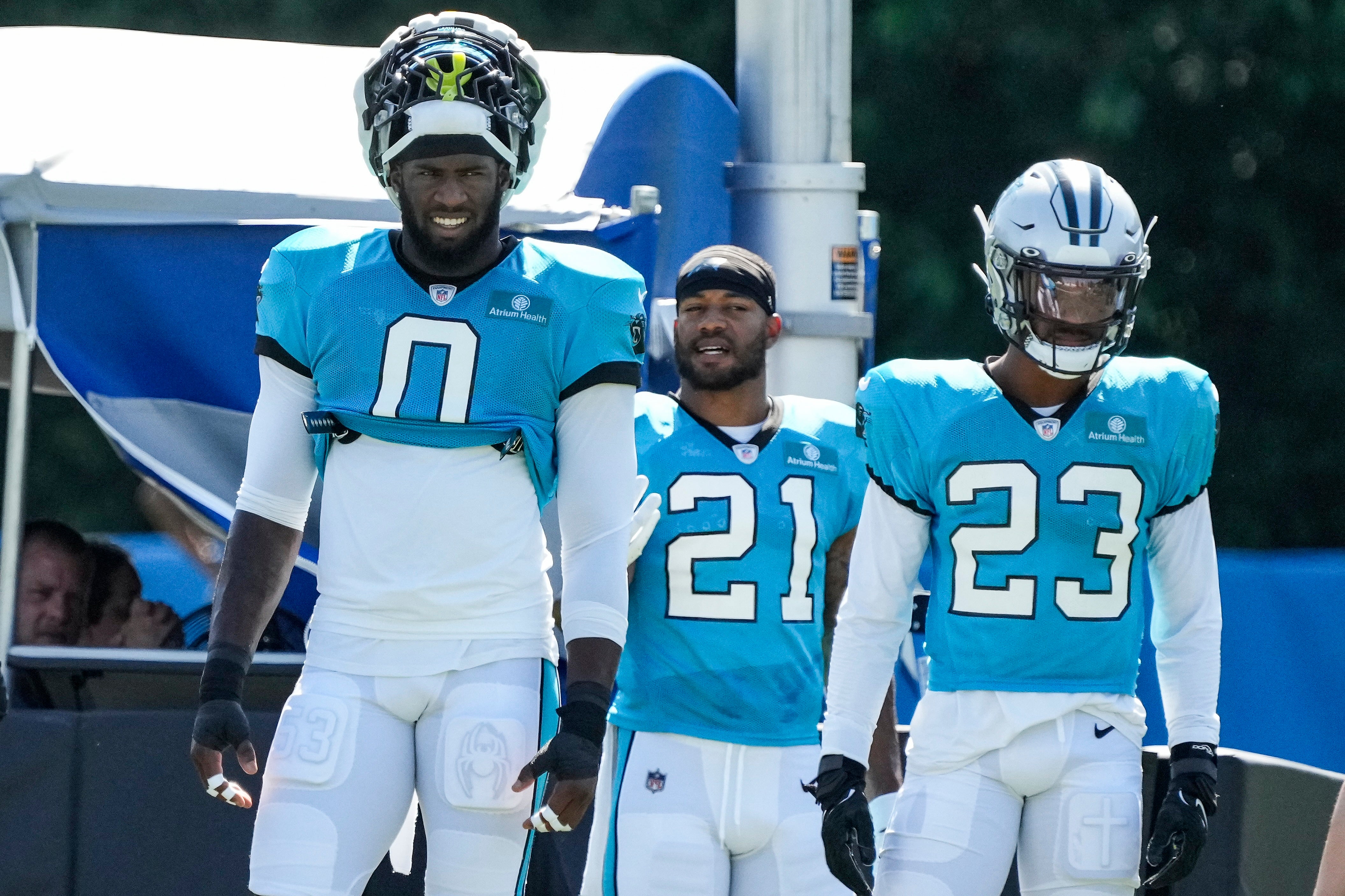 ul 31, 2023; Spartanburg, SC, USA; Carolina Panthers linebacker Brian Burns (0), safety Jeremy Chinn (21) and cornerback CJ Henderson (23) watch practice during training camp at Wofford College. Mandatory Credit: Jim Dedmon-USA TODAY Sports