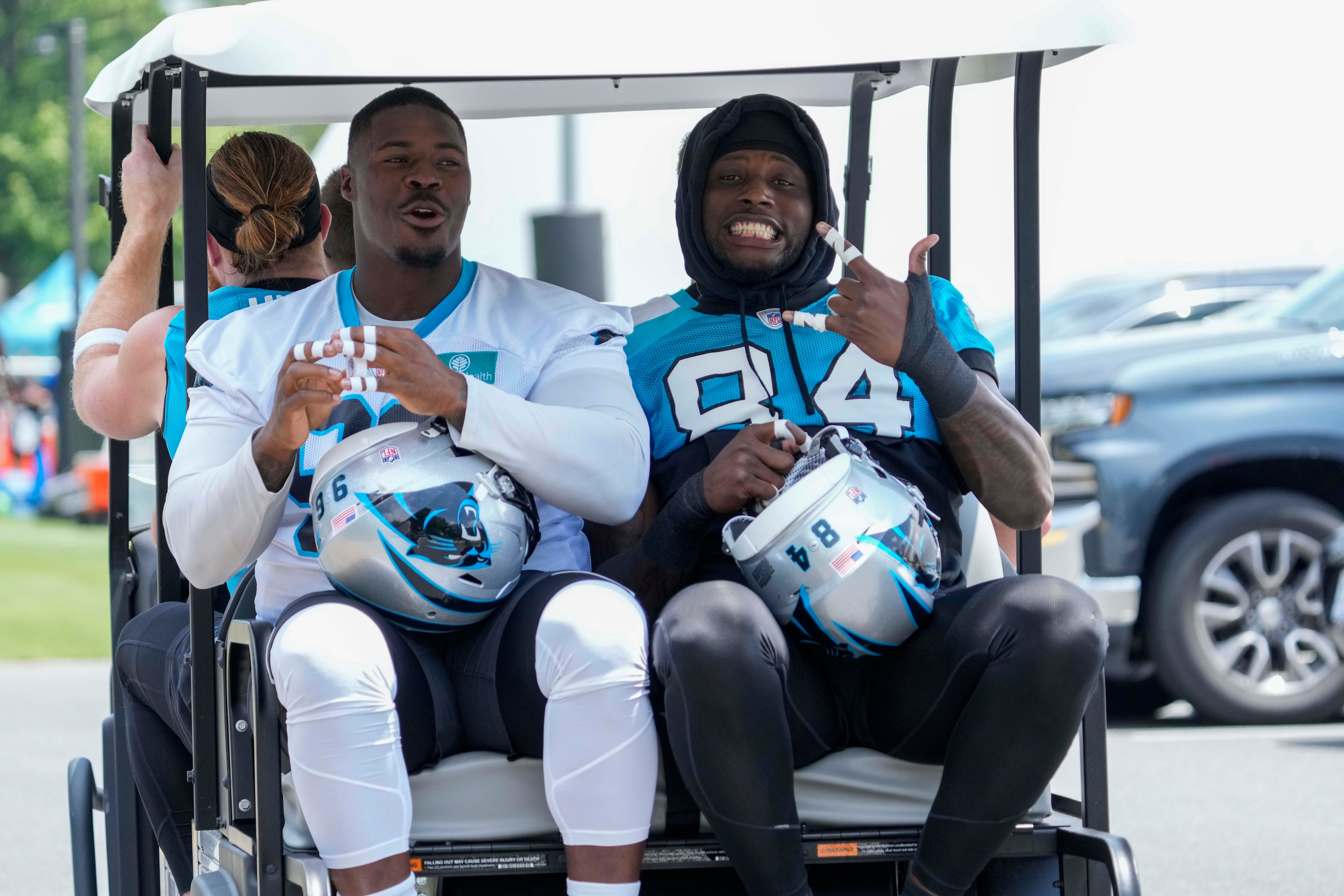 Jun 14, 2023; Charlotte, NC, USA; Carolina Panthers defensive tackle DeShawn Williams (96) and tight end Stephen Sullivan (84) on the way to practice during the Carolina Panthers minicamp. Mandatory Credit: Jim Dedmon-USA TODAY Sports
