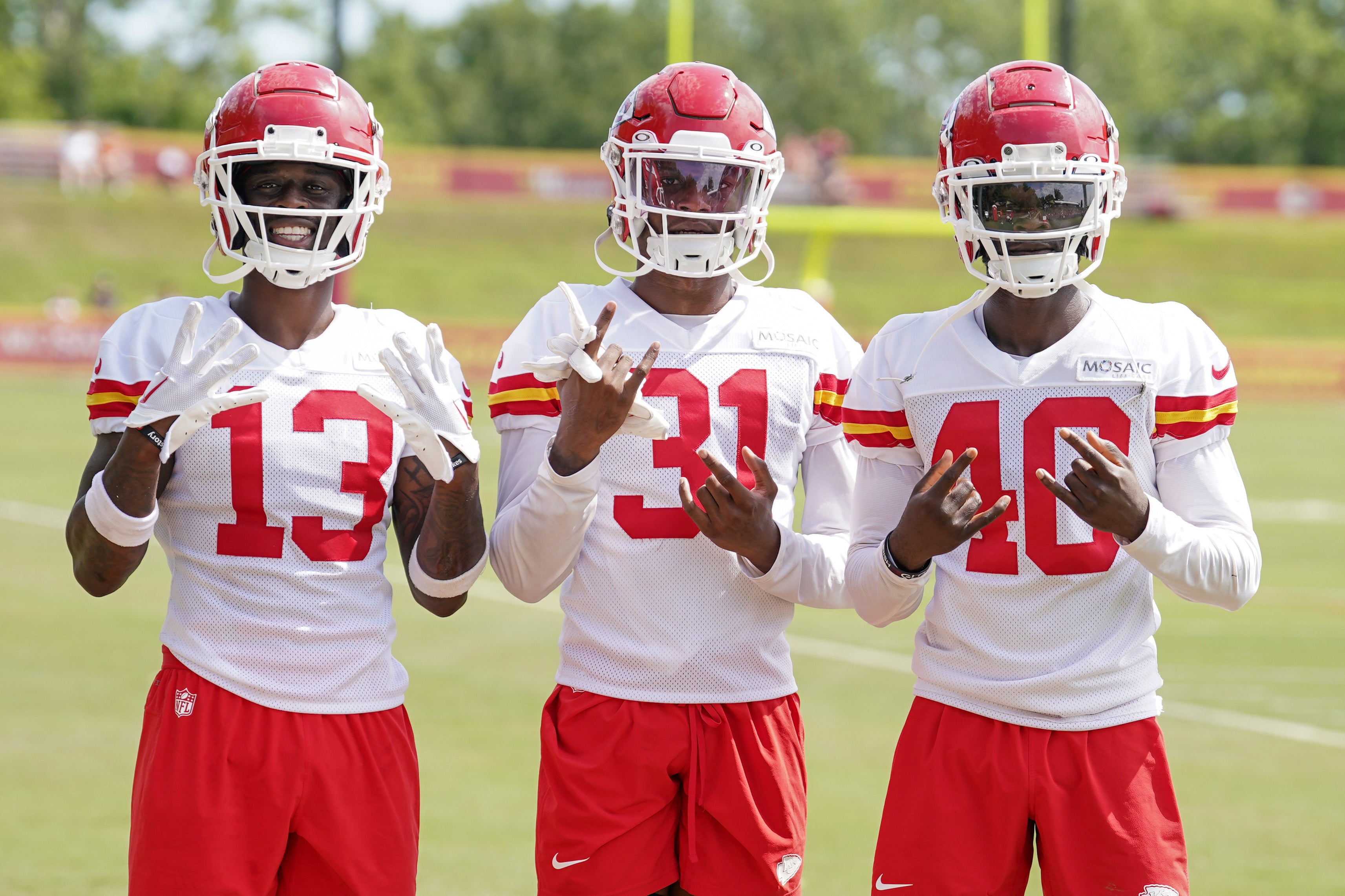 Jul 24, 2023; St. Joseph, MO, USA; Kansas City Chiefs safety Nazeeh Johnson (13) and cornerback Nic Jones (31) and cornerback Ekow Boye-Doe (40 pose for a photo on field after training camp at Missouri Western State University. Mandatory Credit: Denny Medley-USA TODAY Sports
