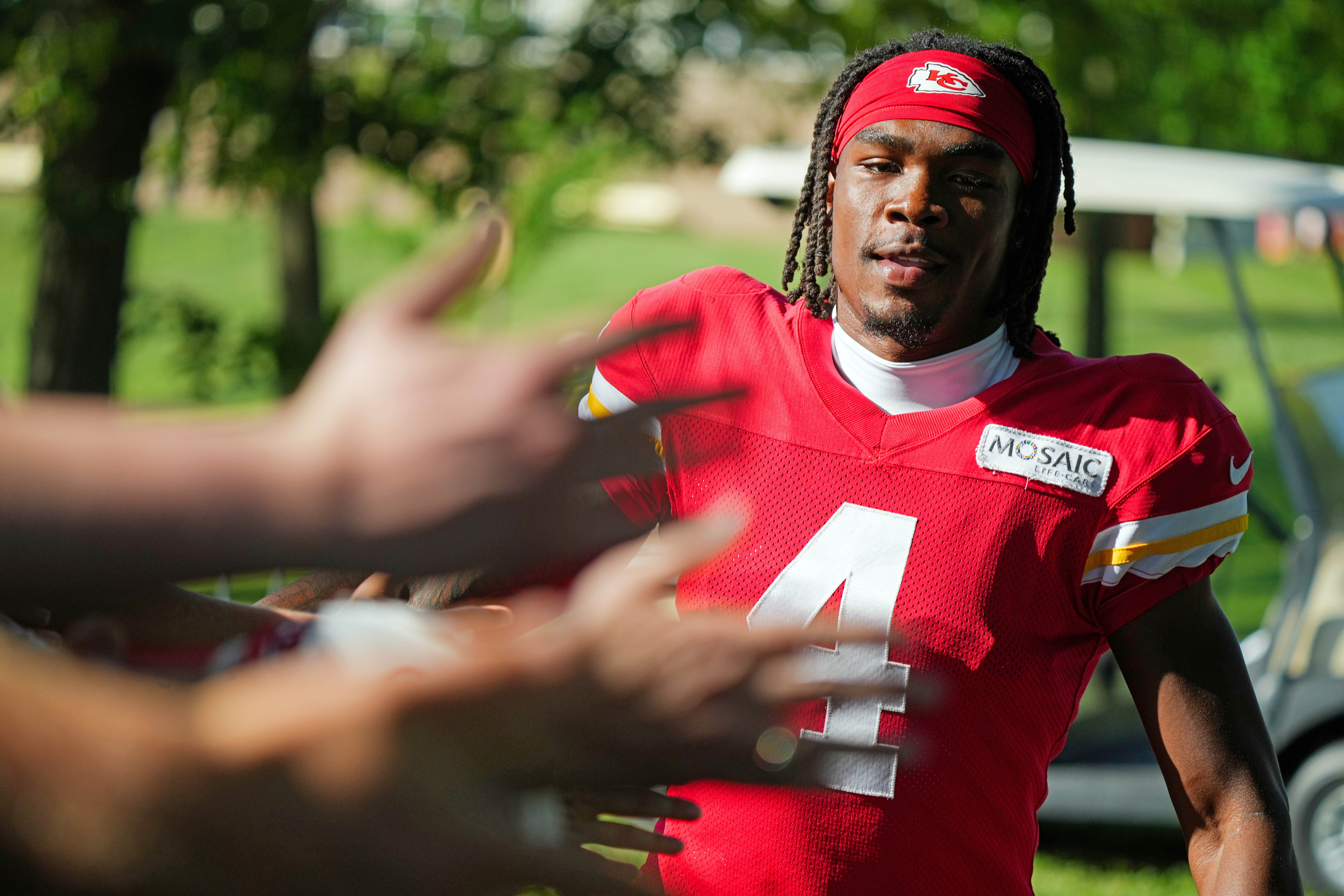Jul 28, 2023; St. Joseph, MO, USA; Kansas City Chiefs wide receiver Rashee Rice (4) greets fans as he arrives prior to training camp at Missouri Western State University. Mandatory Credit: Jay Biggerstaff-USA TODAY Sports