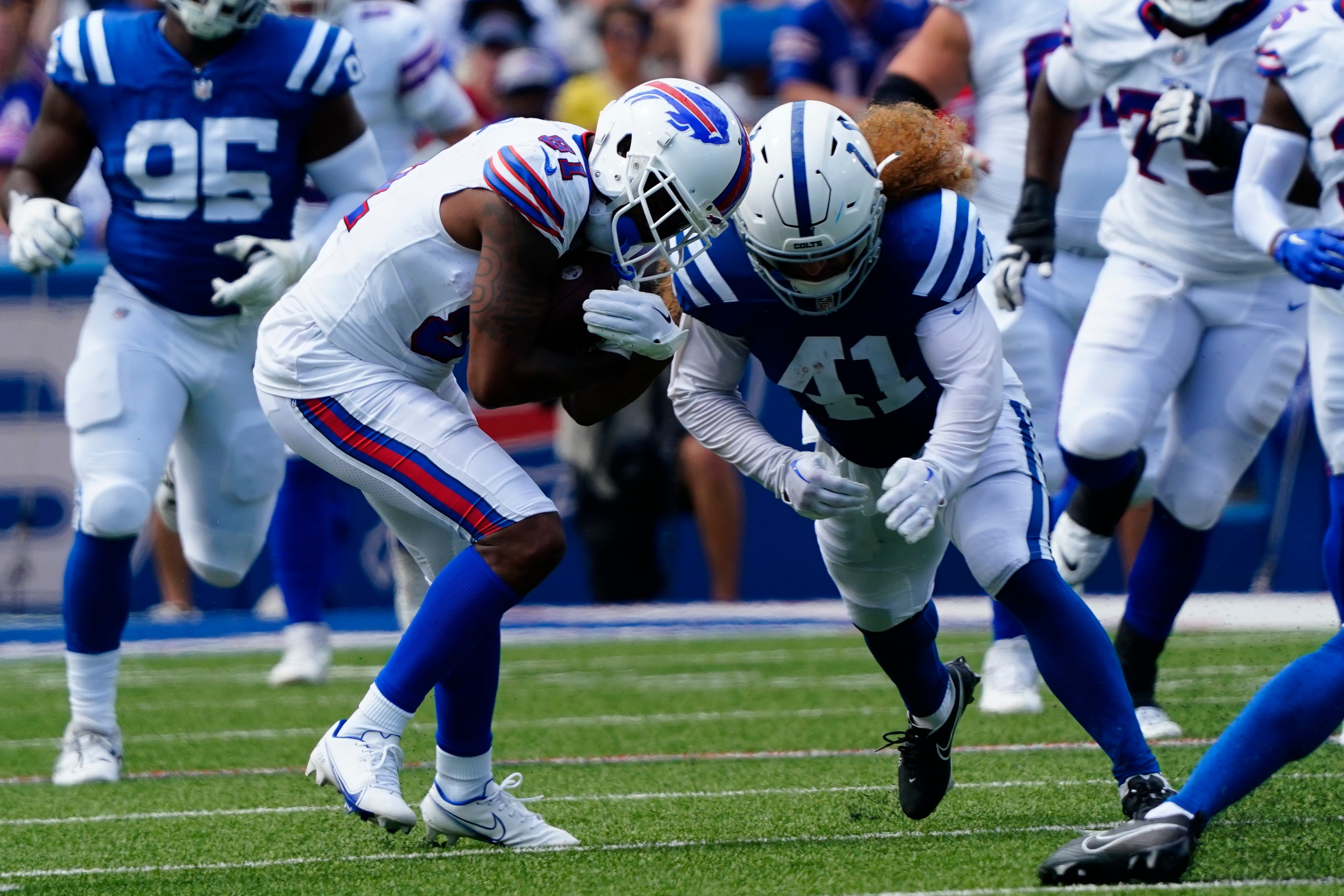 Aug 12, 2023; Orchard Park, New York, USA; Indianapolis Colts linebacker Grant Stuard (41) tackles Buffalo Bills wide receiver KeeSean Johnson (81) during the second half at Highmark Stadium.