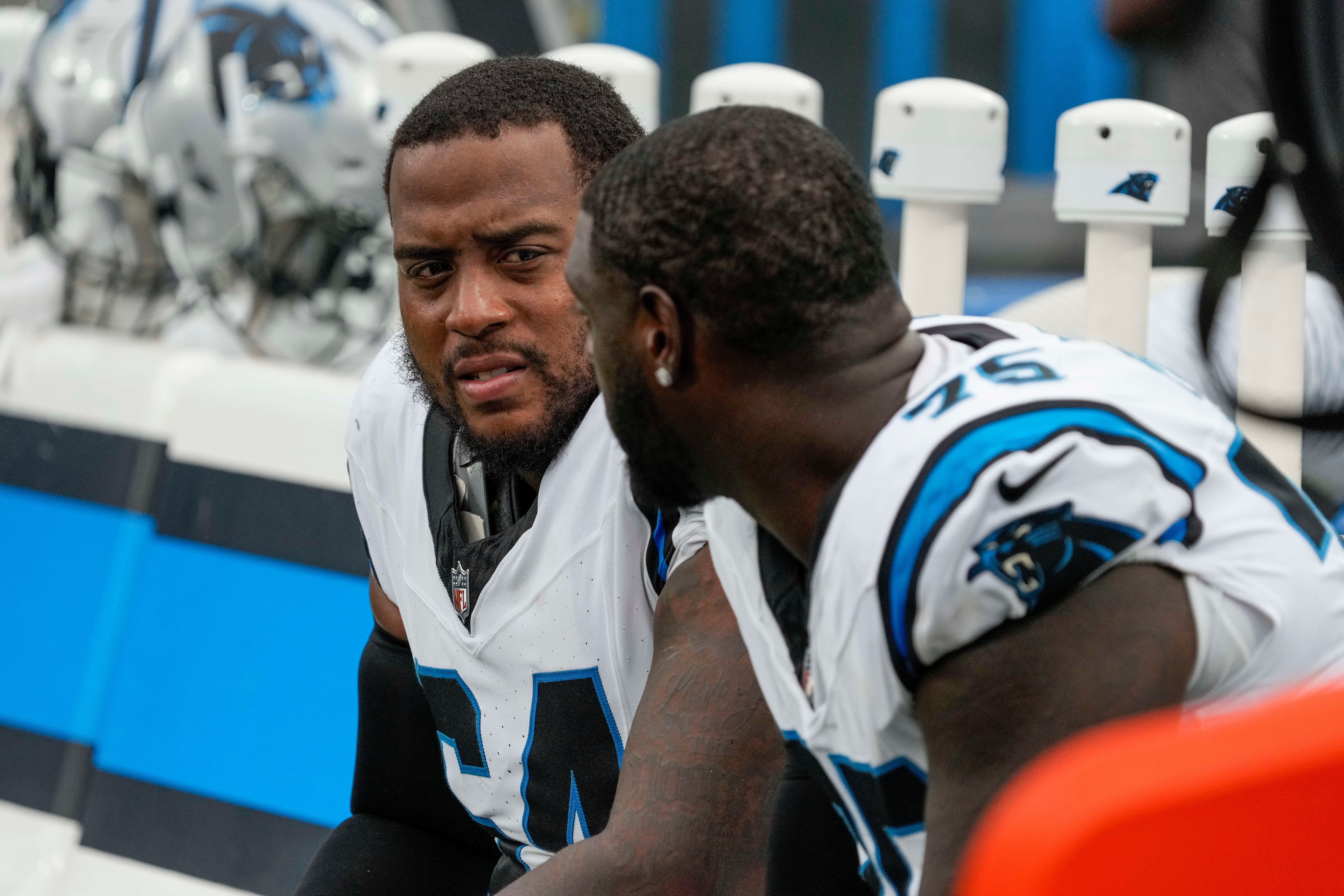 Aug 12, 2023; Charlotte, North Carolina, USA; Carolina Panthers guard Justin McCray (64) talks with offensive tackle Cameron Erving (75) during the second half against the New York Jets at Bank of America Stadium. Mandatory Credit: Jim Dedmon-USA TODAY Sports.