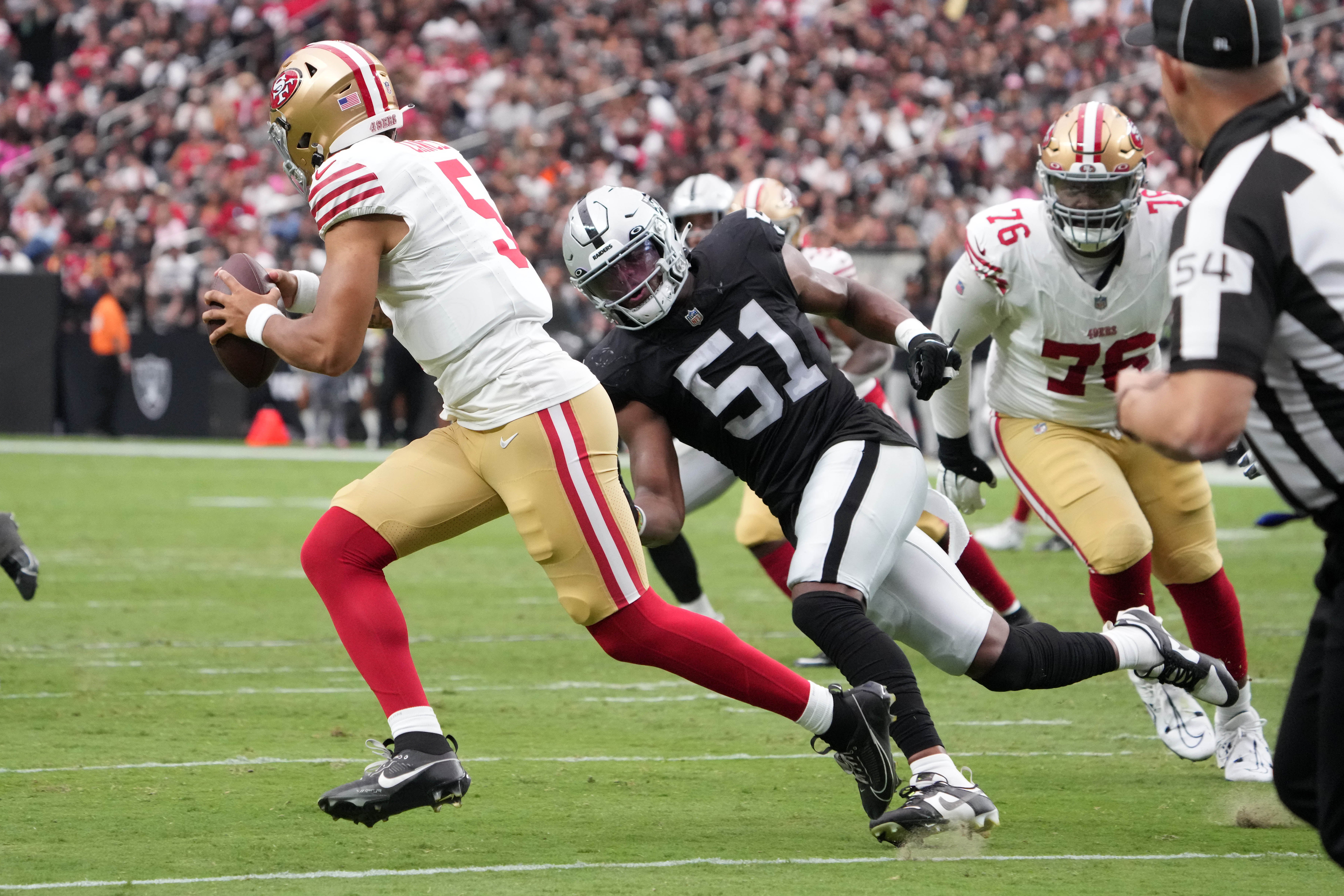 Aug 13, 2023; Paradise, Nevada, USA; San Francisco 49ers quarterback Trey Lance (5) is pressured by Las Vegas Raiders defensive end Malcolm Koonce (51) in the first half at Allegiant Stadium. Mandatory Credit: Kirby Lee-USA TODAY Sport