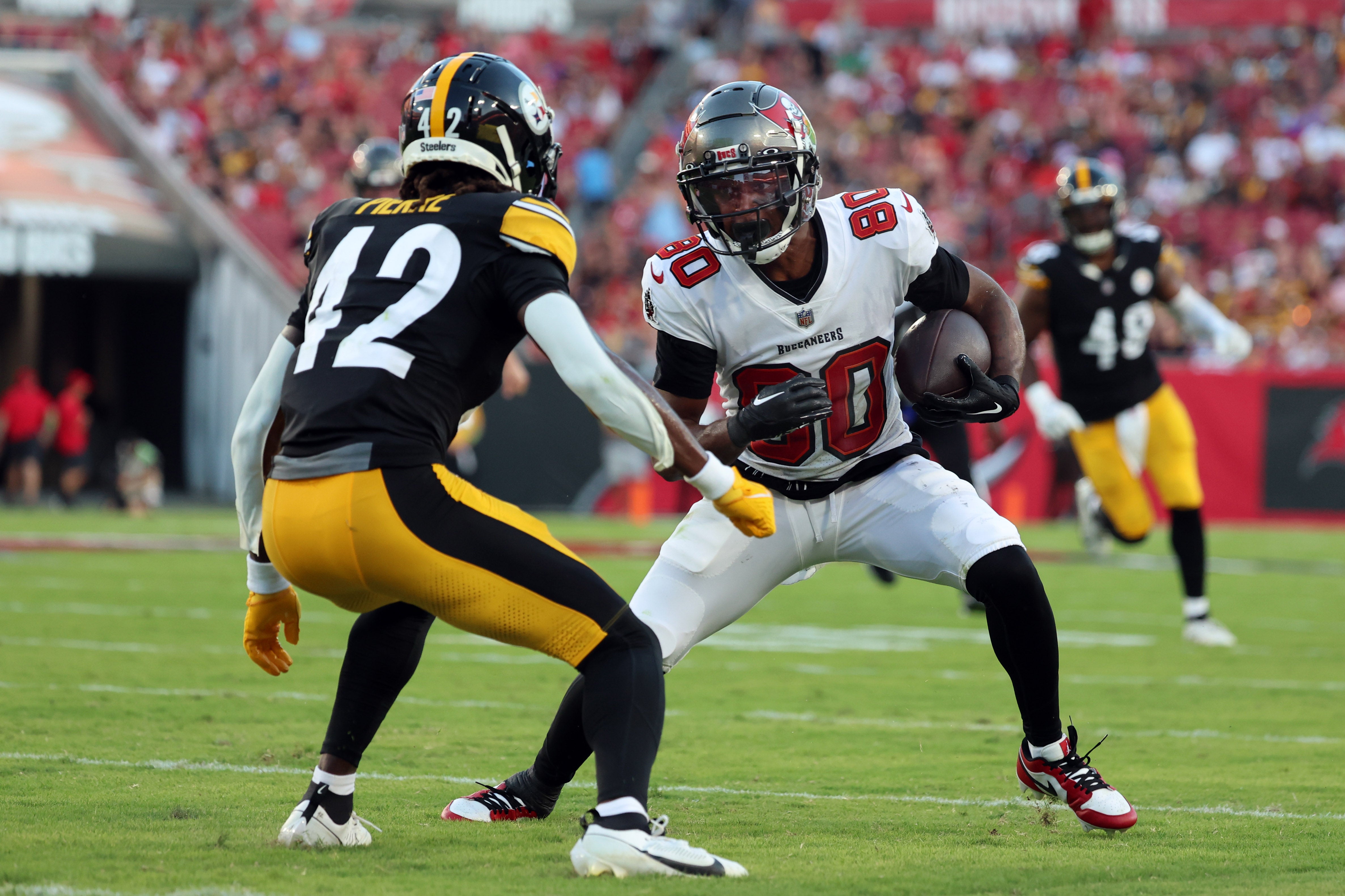 Aug 11, 2023; Tampa, Florida, USA; Tampa Bay Buccaneers wide receiver Kaylon Geiger (80) runs with the ball as Pittsburgh Steelers cornerback James Pierre (42) defends during the first half at Raymond James Stadium. Mandatory Credit: Kim Klement Neitzel-USA TODAY Sports  