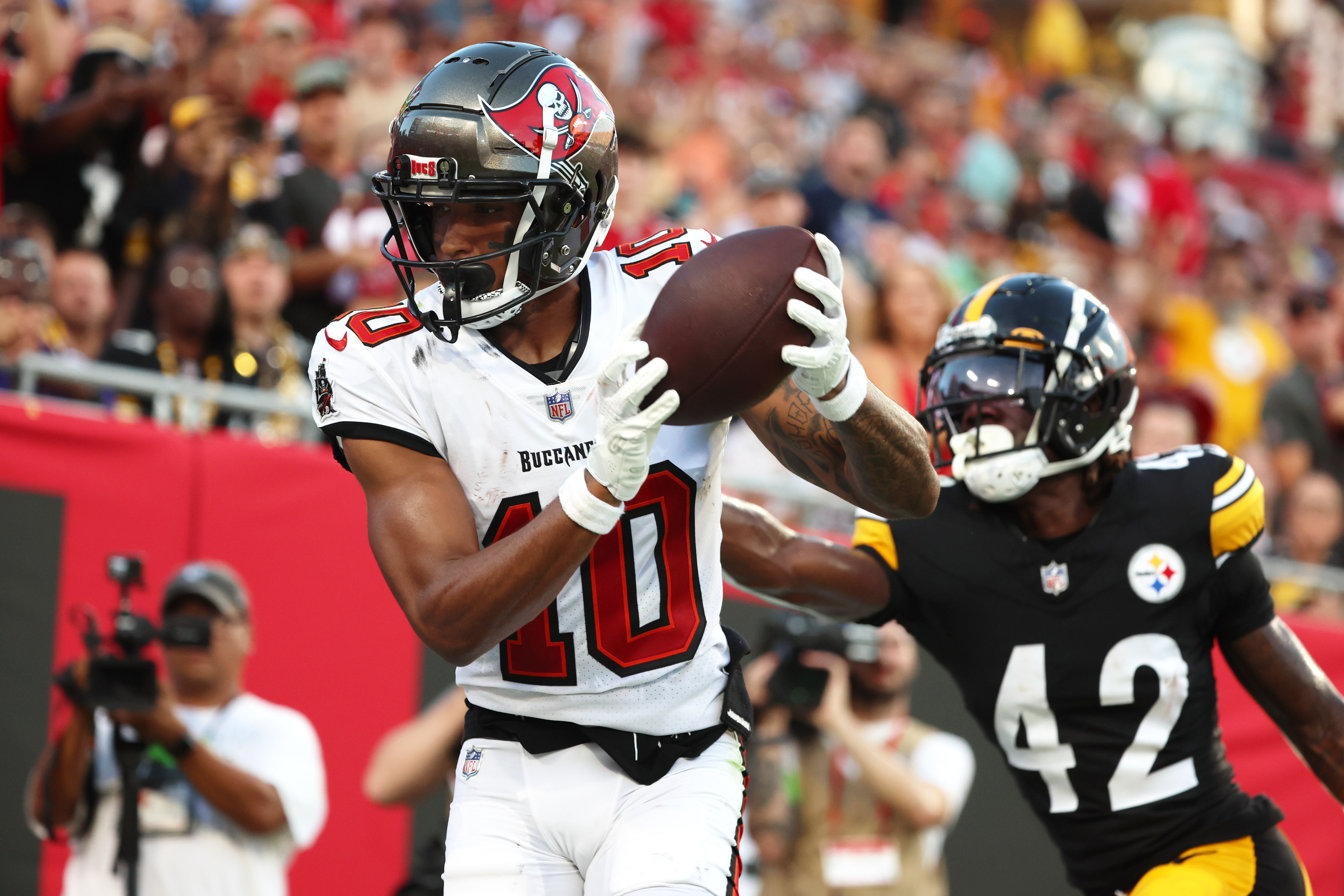 Aug 11, 2023; Tampa, Florida, USA; Tampa Bay Buccaneers wide receiver Trey Palmer (10) catches the ball for a touchdown as Pittsburgh Steelers cornerback James Pierre (42) attempted to defend during the first half at Raymond James Stadium. Mandatory Credit: Kim Klement Neitzel-USA TODAY Sports