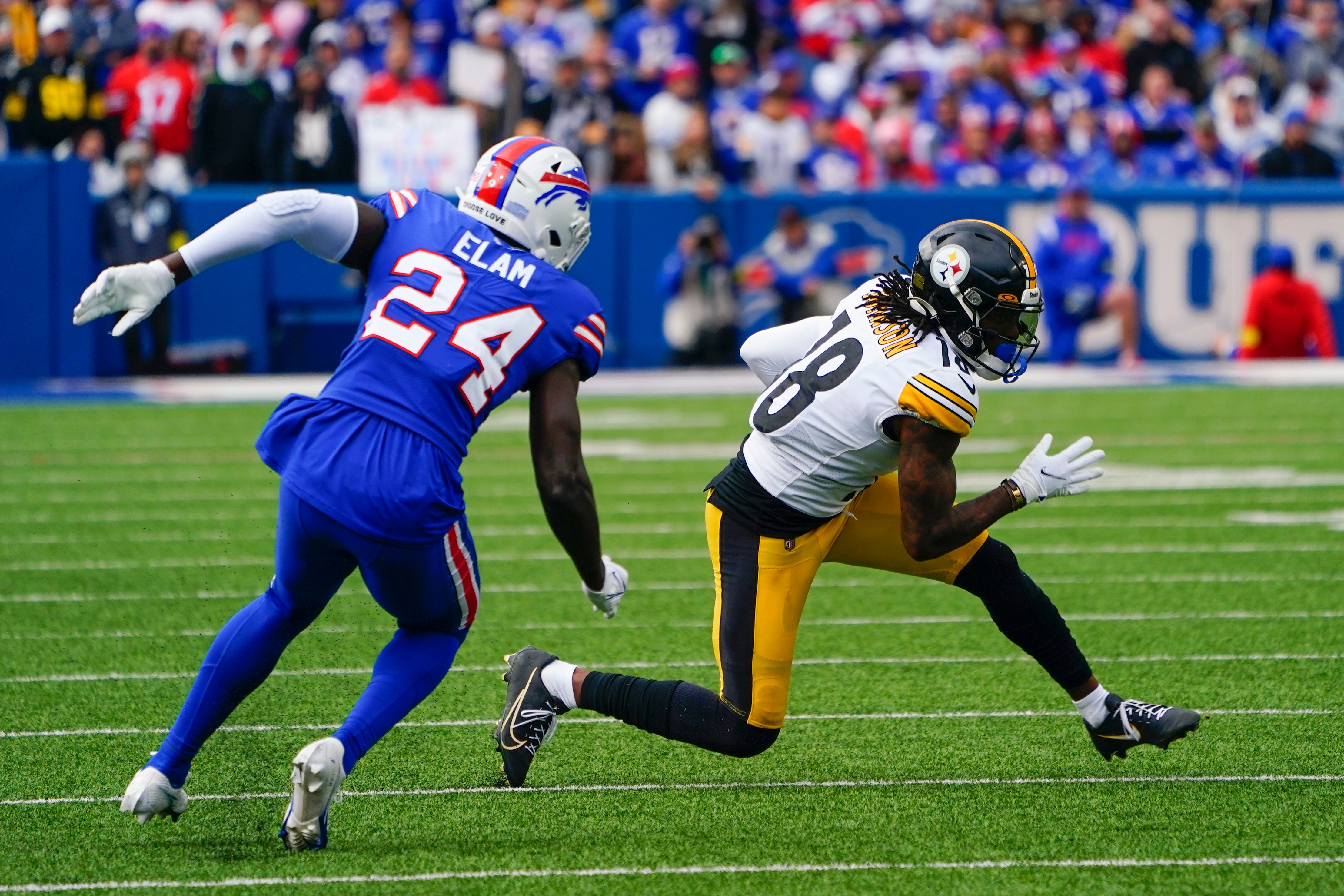 Oct 9, 2022; Orchard Park, New York, USA; Pittsburgh Steelers wide receiver Diontae Johnson (18) runs with the ball after making a catch with Buffalo Bills cornerback Kaiir Elam (24) defending during the second half at Highmark Stadium. Mandatory Credit: Gregory Fisher-USA TODAY Sports