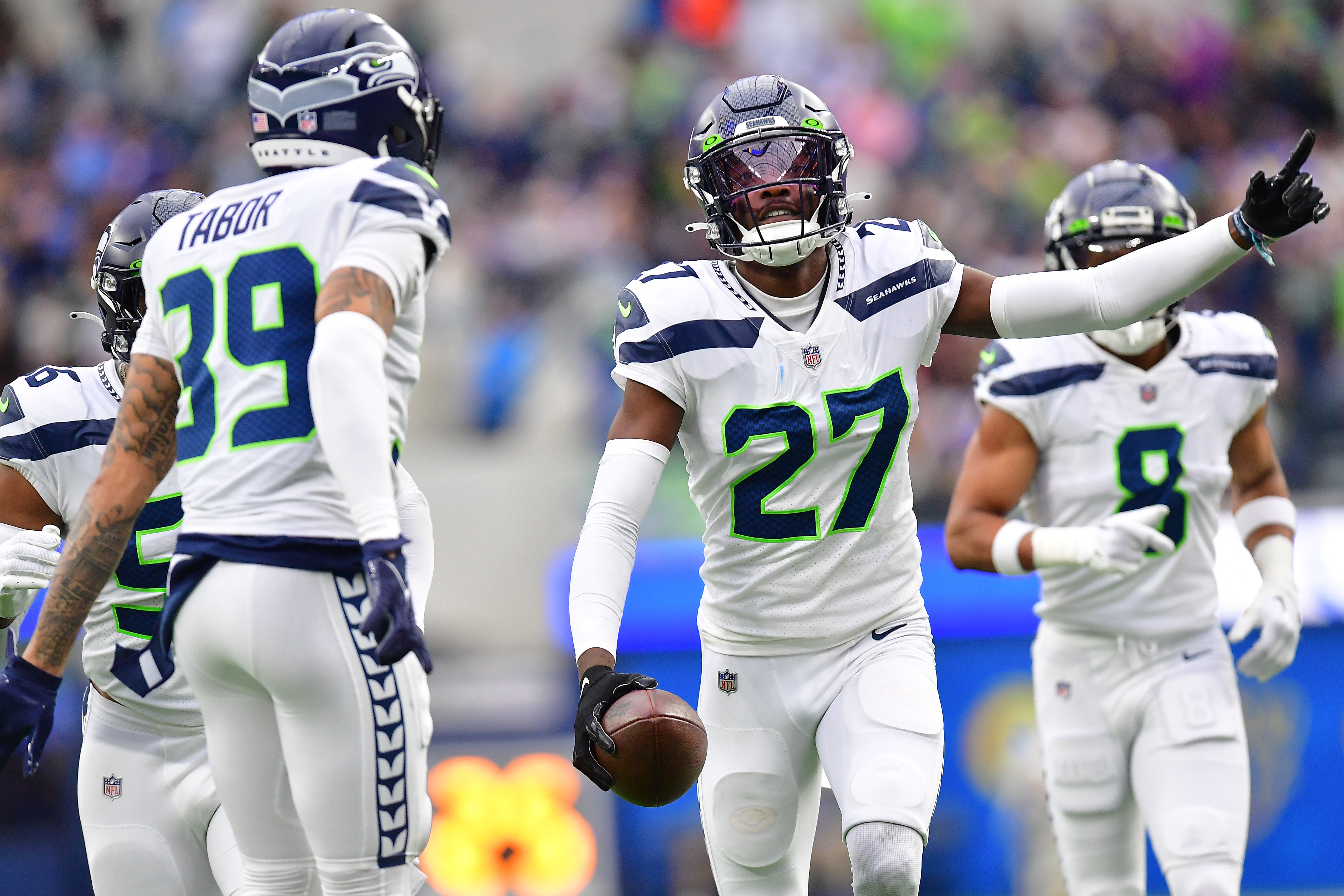 Dec 4, 2022; Inglewood, California, USA; Seattle Seahawks cornerback Tariq Woolen (27) celebrates after intercepting a pass intended for Los Angeles Rams running back Kyren Williams (23) during the first half at SoFi Stadium. Mandatory Credit: Gary A. Vasquez-USA TODAY Sports