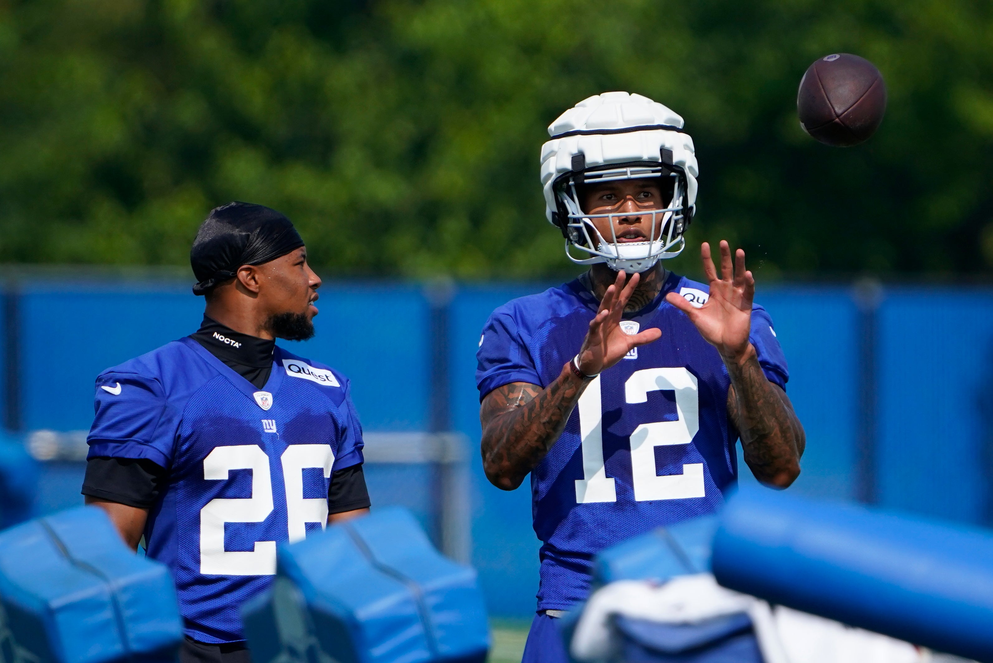 Jul 26, 2023; East Rutherford, NJ, USA; New York Giants running back Saquon Barkley (26) and tight end Darren Waller (12) talk on the first day of training camp at the Quest Diagnostics Training Facility. Mandatory Credit: Danielle Parhizkaran-USA TODAY Sports