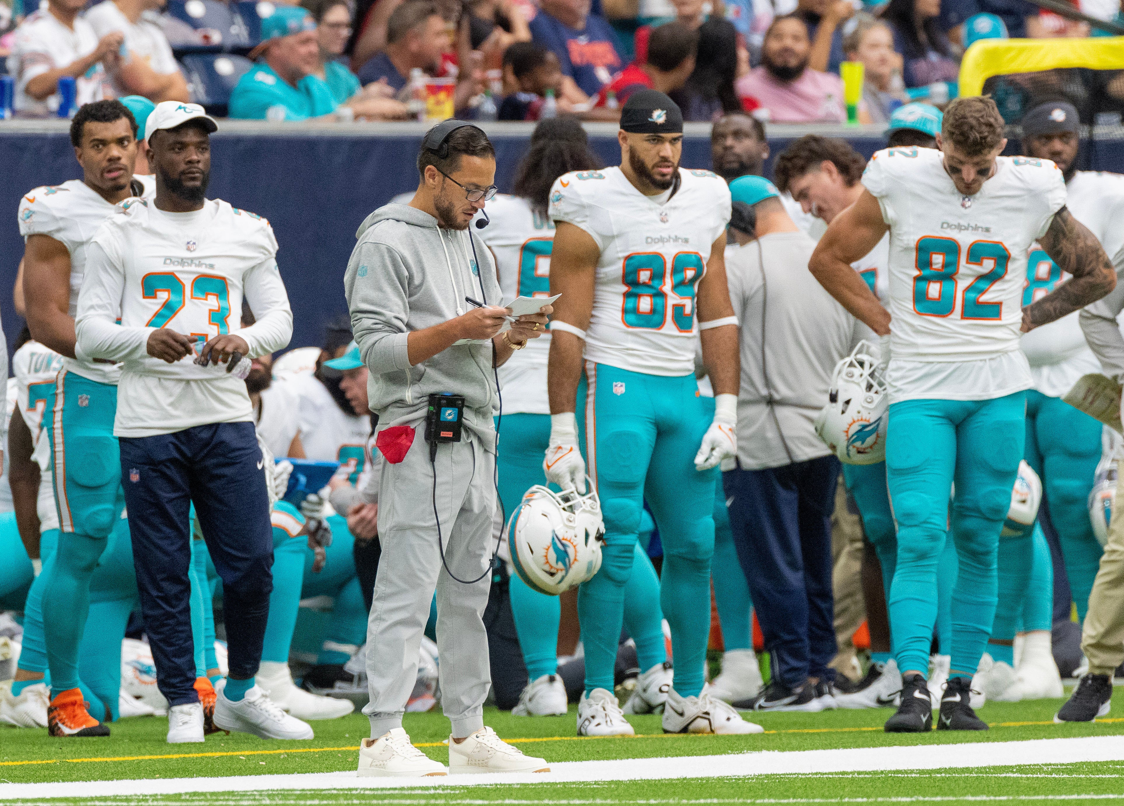 Miami Dolphins head coach Mike McDaniels looks as his play card while the Dolphins play against the Houston Texans in the first quarter at NRG Stadium. Mandatory Credit: Thomas Shea-USA TODAY Sports