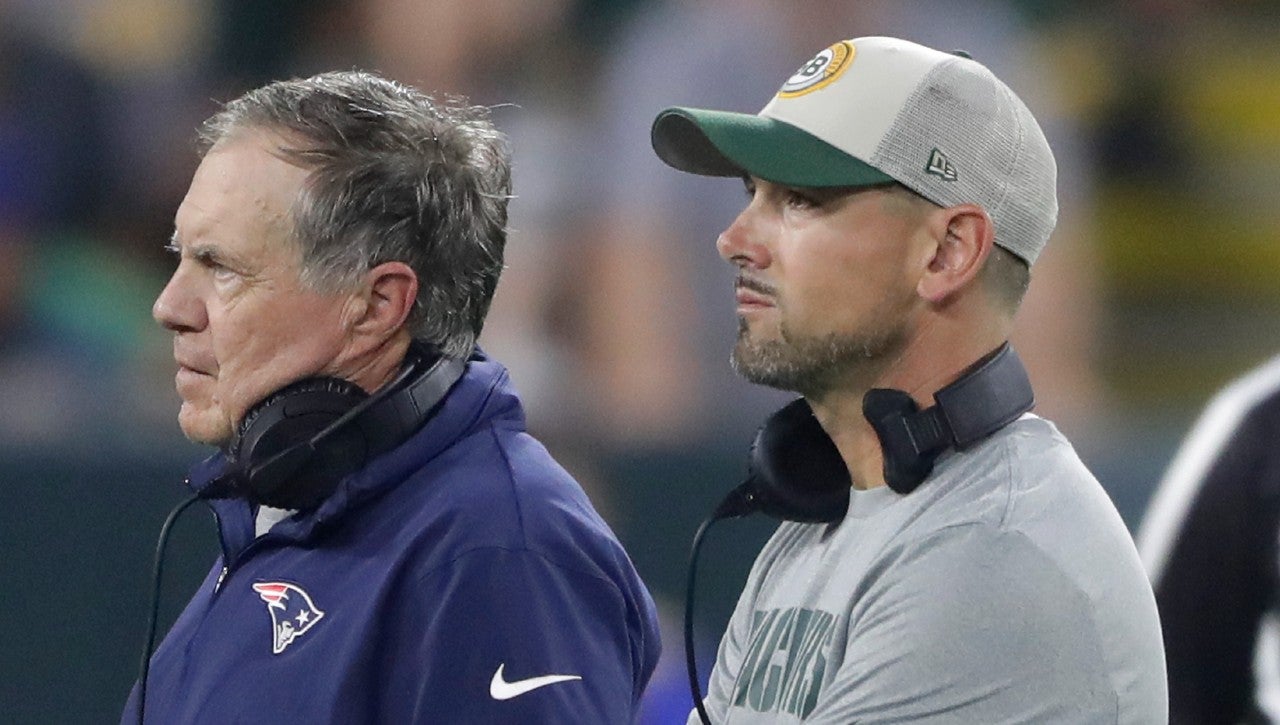 Aug 19, 2023; Green Bay, WI, USA; Green Bay Packers head coach Matt LaFleur and New England Patriots head coach Bill Bellichick watch as New England Patriots cornerback Isaiah Bolden (7) is taken off the field following an injury during their preseason football game at Lambeau Field. The game was suspended in the fourth quarter following the injury. Mandatory Credit: William Glasheen-USA TODAY Sports