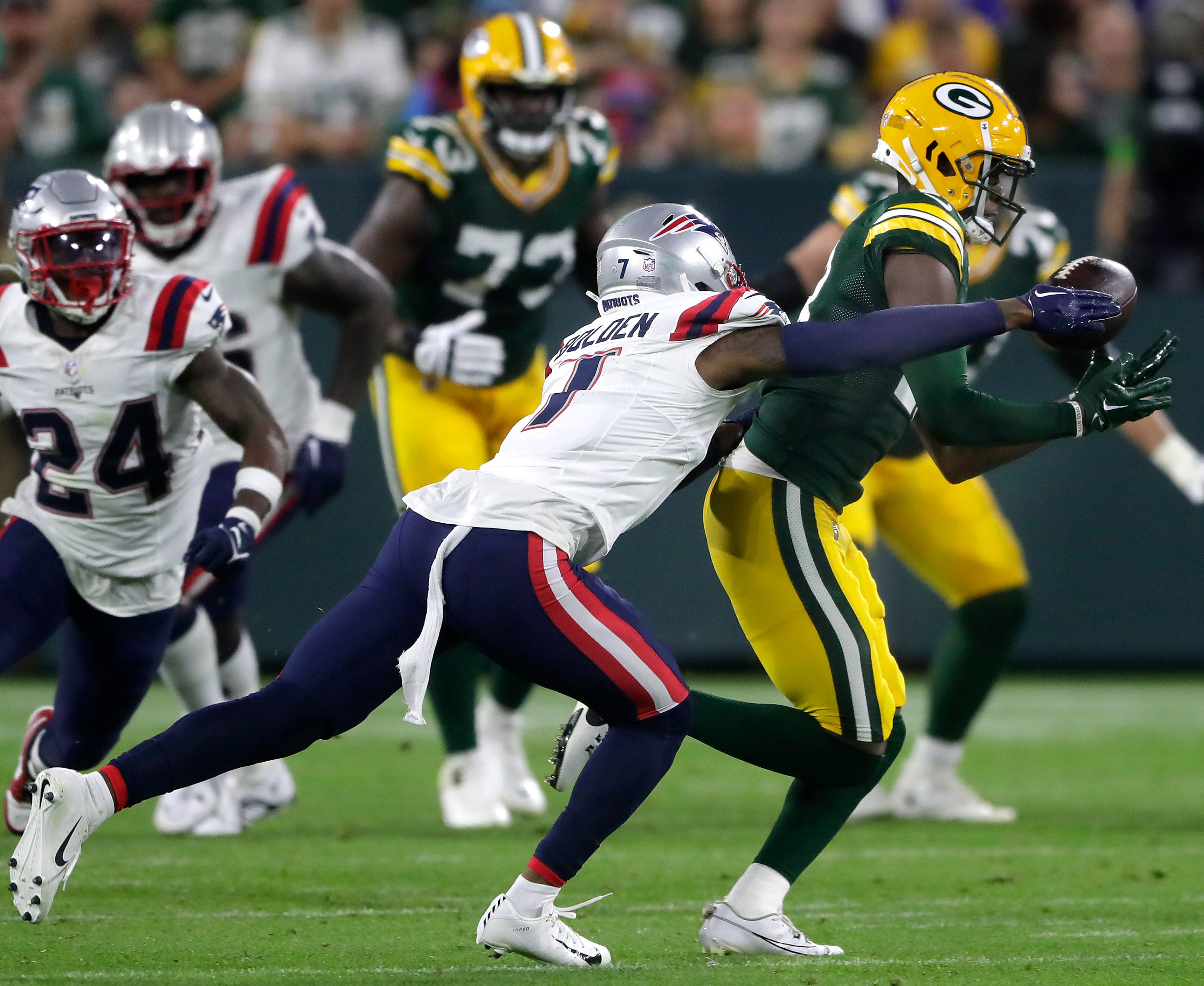 Green Bay Packers wide receiver Malik Heath (18) catches a pass in front of New England Patriots cornerback Isaiah Bolden (7) during their preseason football game Saturday, August 19, 2023, at Lambeau Field in Green Bay, Wis. The game was suspended in the fourth quarter following an injury to New England Patriots cornerback Isaiah Bolden (7). Wm. Glasheen USA TODAY NETWORK-Wisconsin