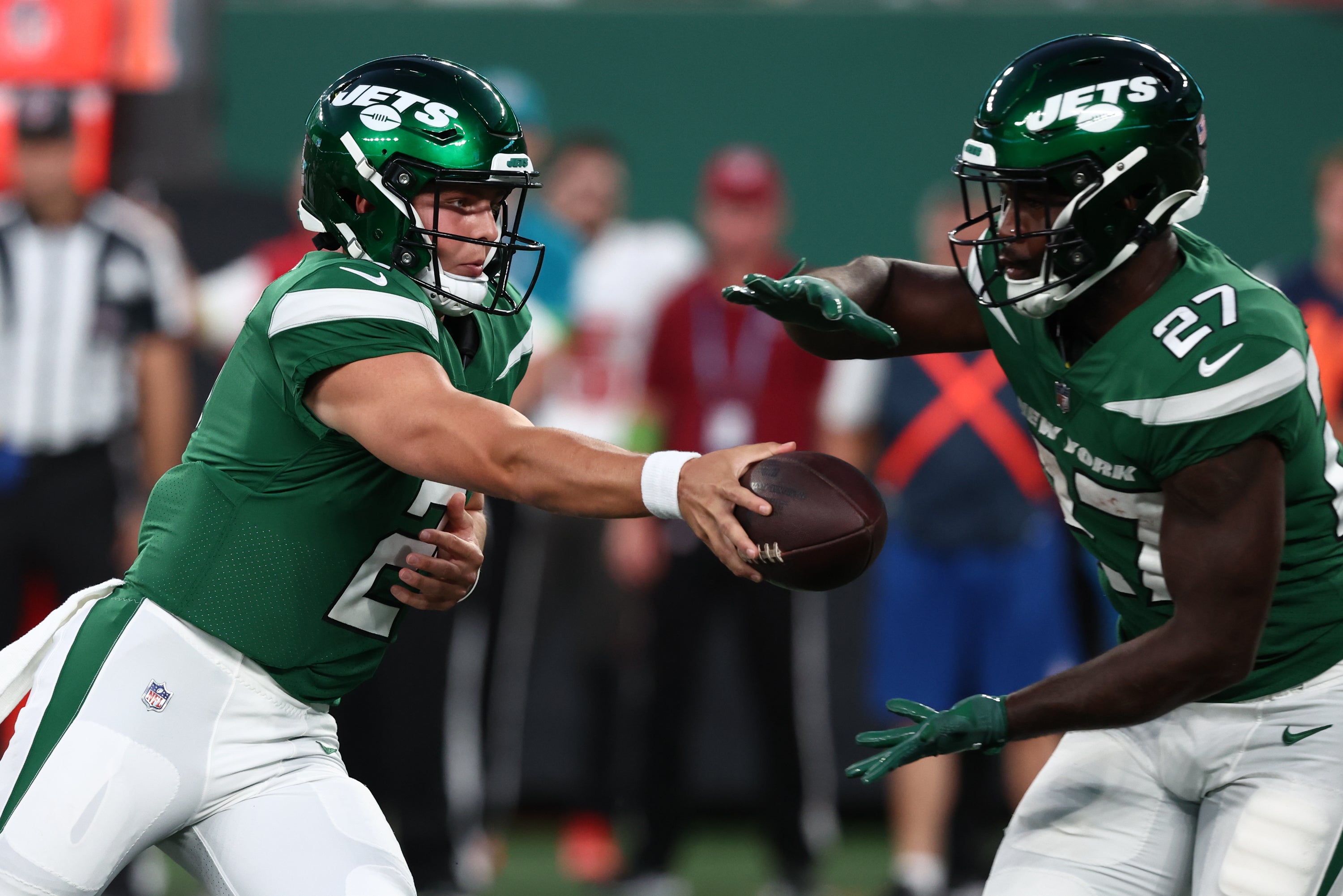 New York Jets quarterback Zach Wilson (2) hands the ball to New York Jets running back Zonovan Knight (27) against the Tampa Bay Buccaneers during the first half at MetLife Stadium.  Ed Mulholland-USA TODAY Sports