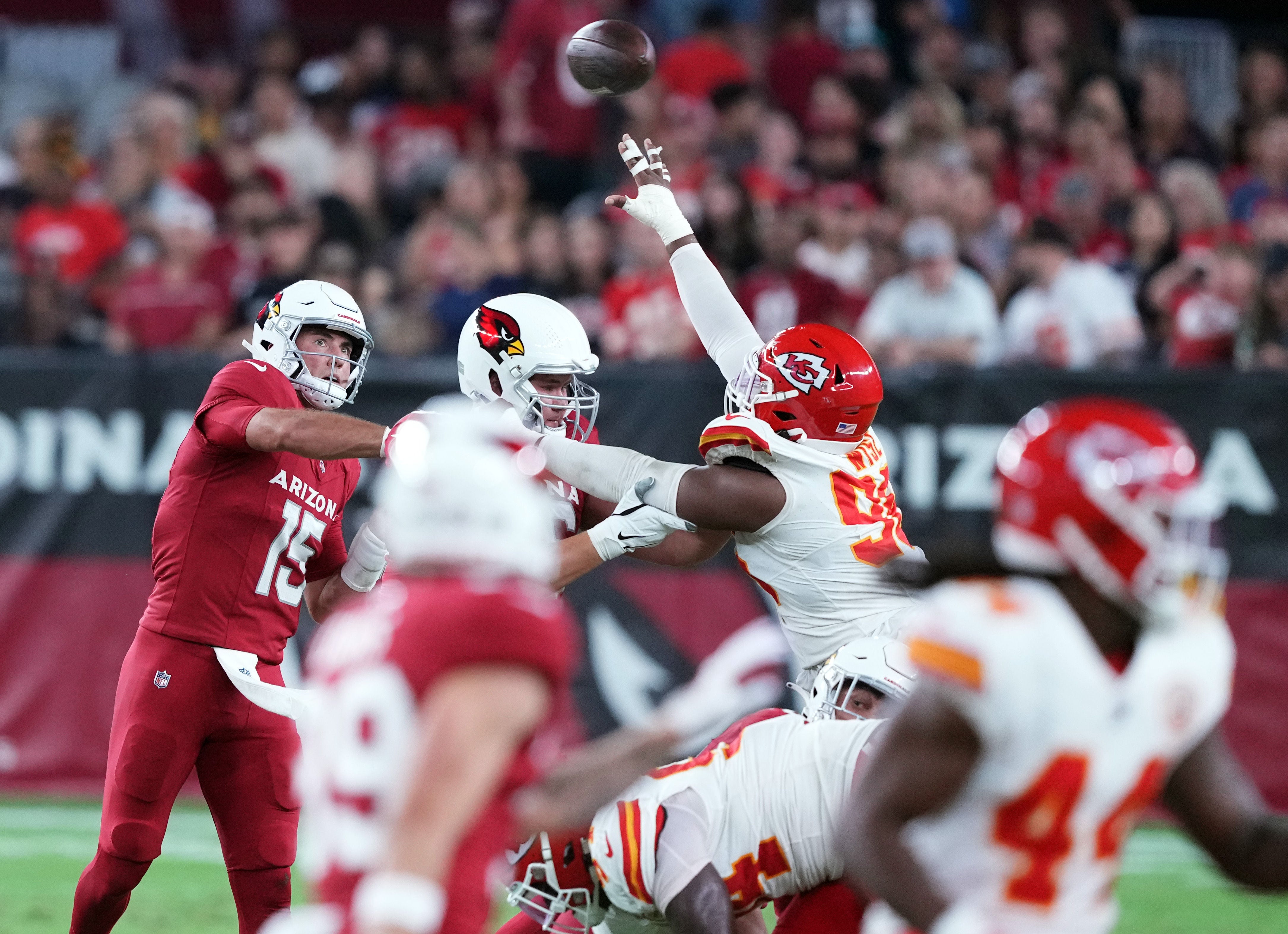 Aug 19, 2023; Glendale, Arizona, USA; Arizona Cardinals quarterback Clayton Tune (15) throws the ball over the reach of Kansas City Chiefs defensive end Daniel Wise (96) during the second half at State Farm Stadium. Mandatory Credit: Joe Camporeale-USA TODAY Sports  