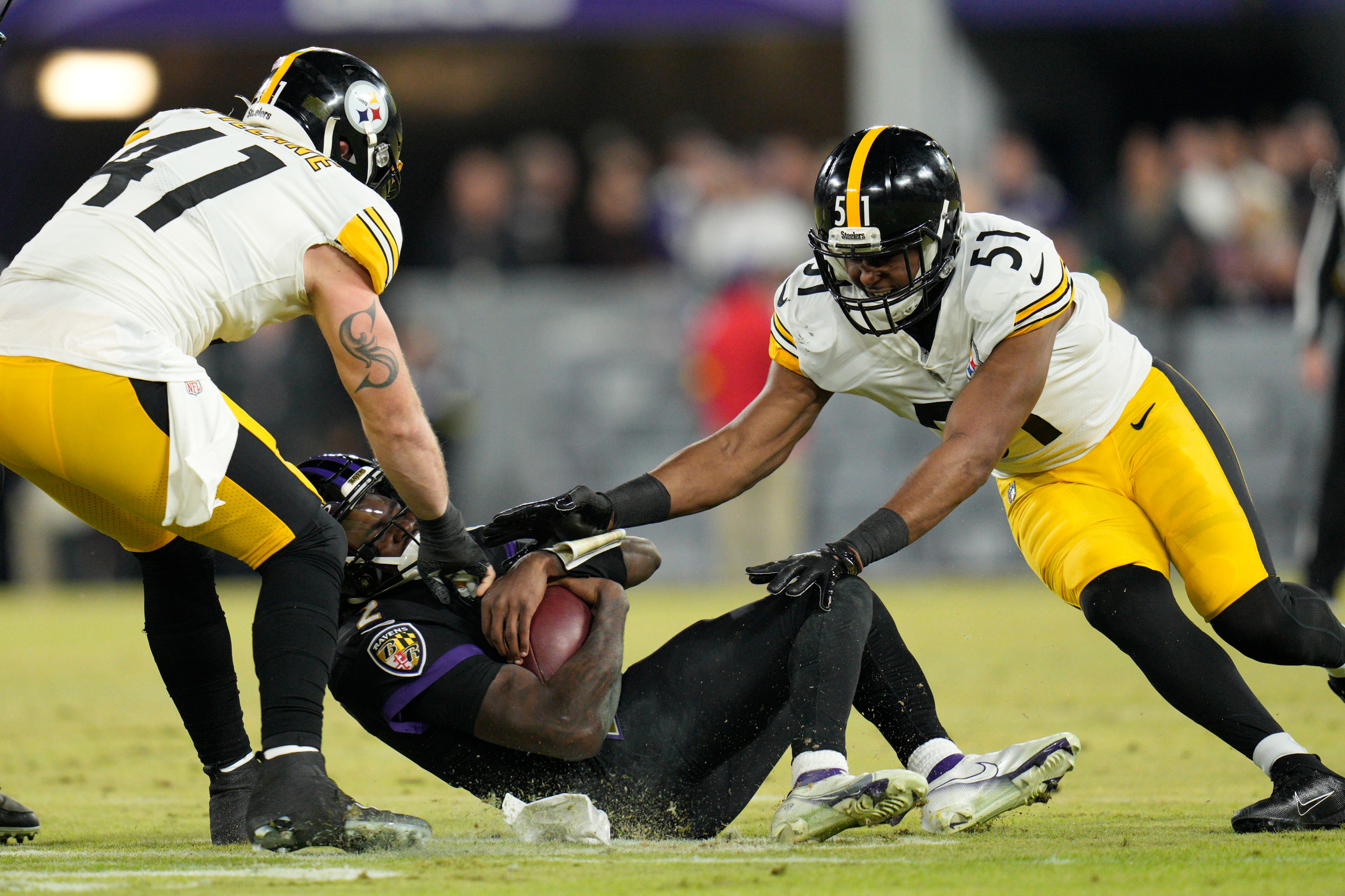 Jan 1, 2023; Baltimore, Maryland, USA; Baltimore Ravens quarterback Tyler Huntley (2) is tackled by Pittsburgh Steelers linebacker Robert Spillane (41) and linebacker Myles Jack (51) during the first half at M&T Bank Stadium. Mandatory Credit: Jessica Rapfogel-USA TODAY Sports