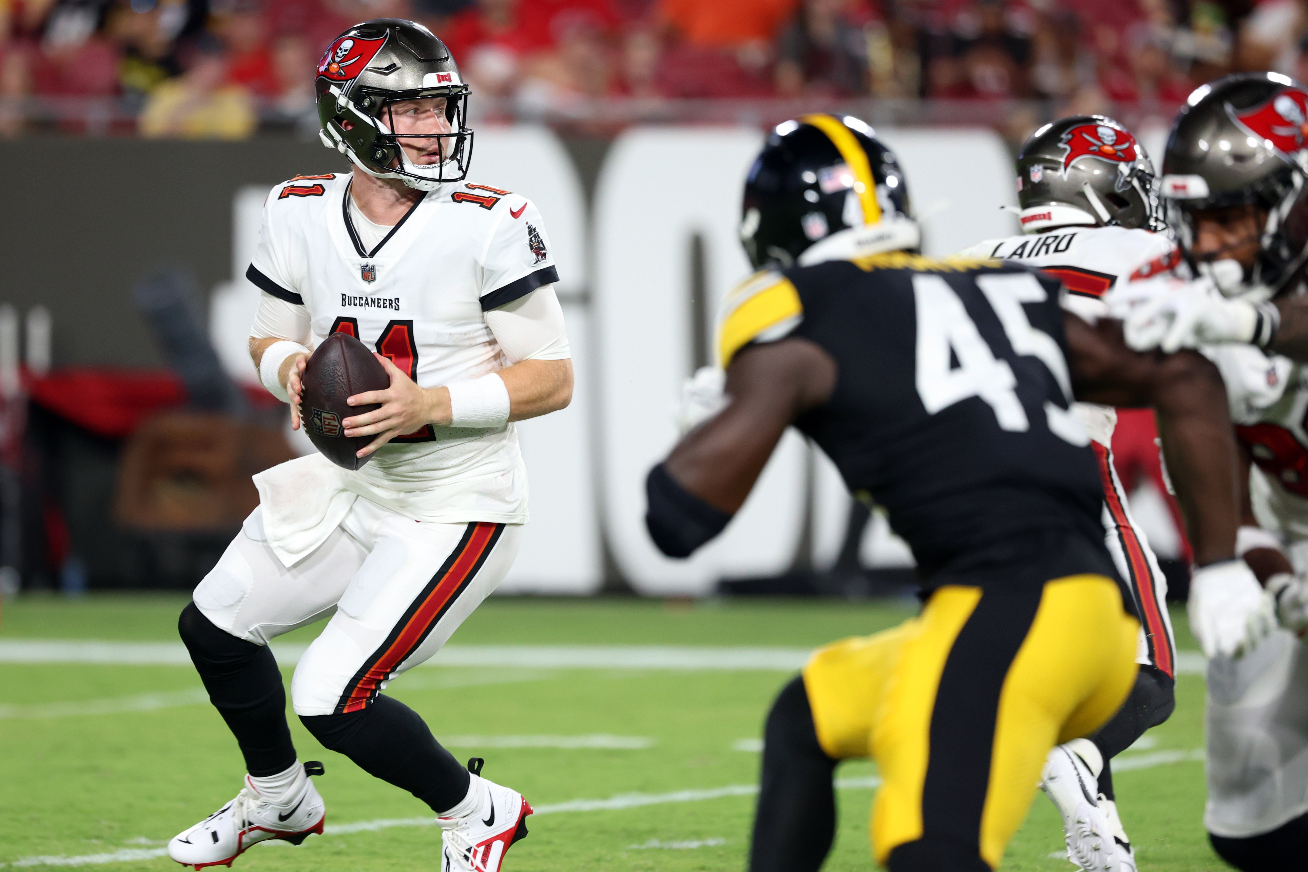 Aug 11, 2023; Tampa, Florida, USA; Tampa Bay Buccaneers quarterback John Wolford (11) drops back against the Pittsburgh Steelers during the second half at Raymond James Stadium. Mandatory Credit: Kim Klement Neitzel-USA TODAY Sports