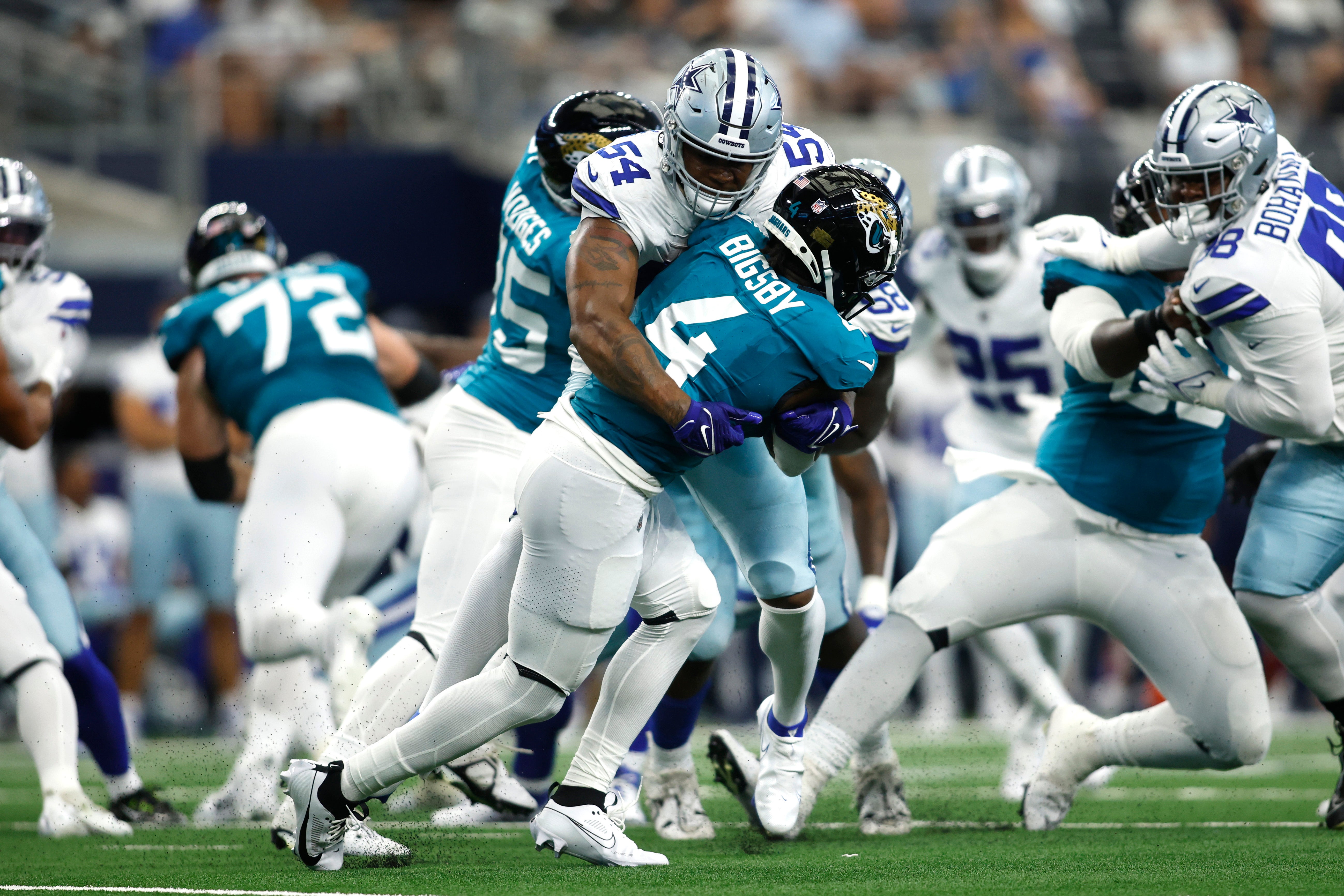 Aug 12, 2023; Arlington, Texas, USA; Dallas Cowboys defensive end Sam Williams (54) tackles Jacksonville Jaguars running back Tank Bigsby (4) in the first quarter at AT&T Stadium. Mandatory Credit: Tim Heitman-USA TODAY Sports