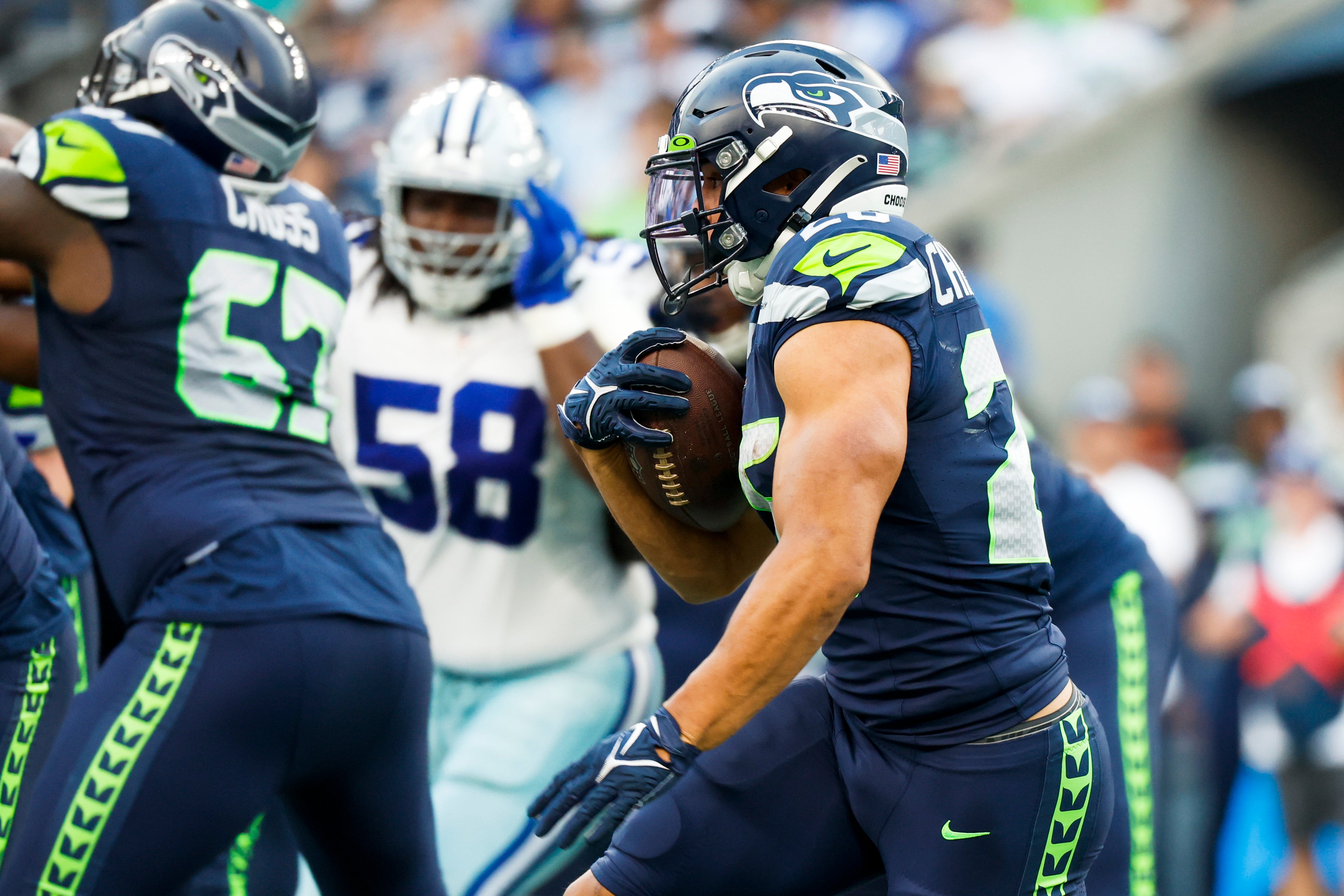 Aug 19, 2023; Seattle, Washington, USA; Seattle Seahawks running back Zach Charbonnet (26) rushes against the Dallas Cowboys during the first quarter at Lumen Field. Mandatory Credit: Joe Nicholson-USA TODAY Sports