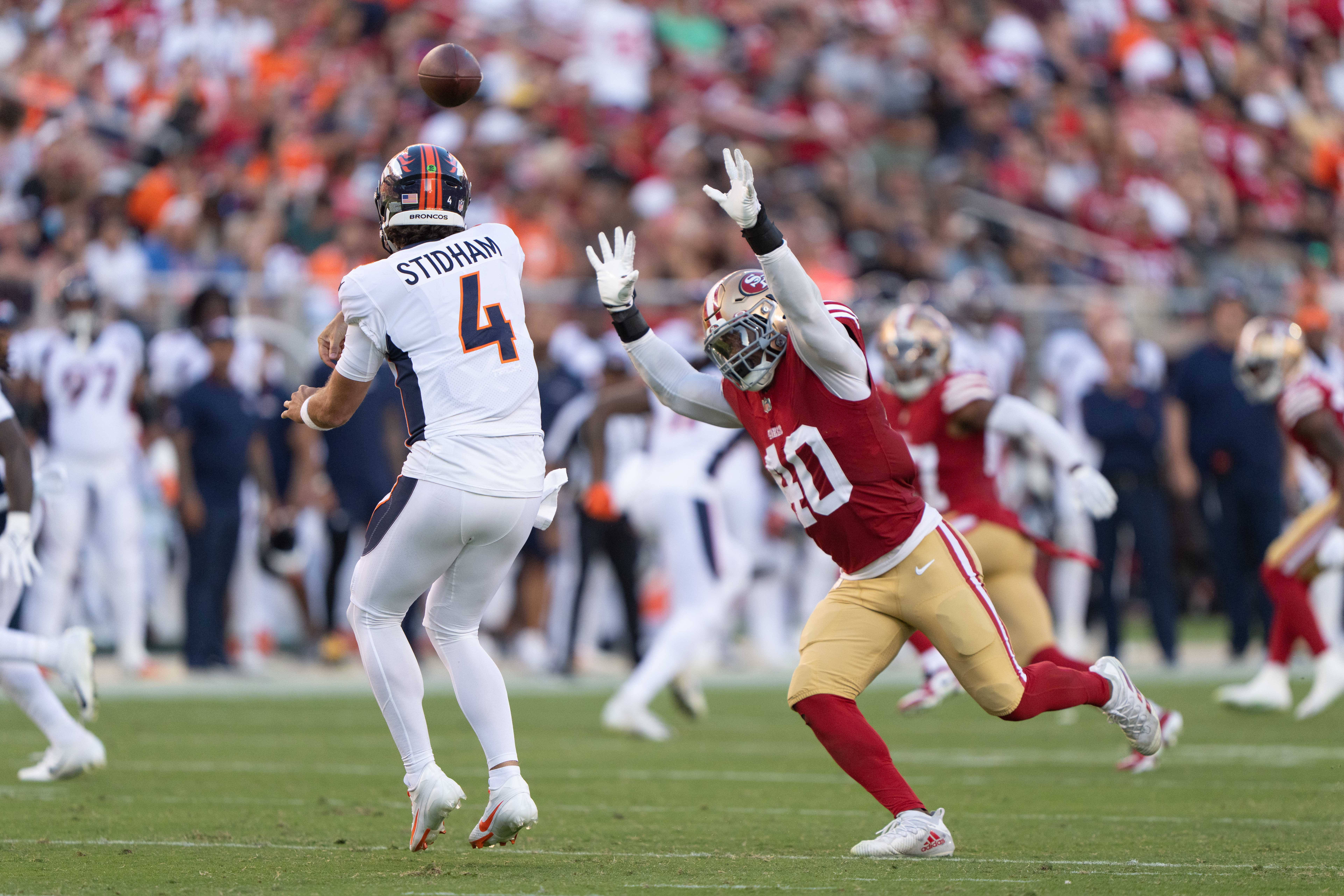 Aug 19, 2023; Santa Clara, California, USA; San Francisco 49ers linebacker Marcelino McCrary-Ball (40) attempts to tackle Denver Broncos quarterback Jarrett Stidham (4) during the second quarter at Levi's Stadium. Mandatory Credit: Stan Szeto-USA TODAY Sports