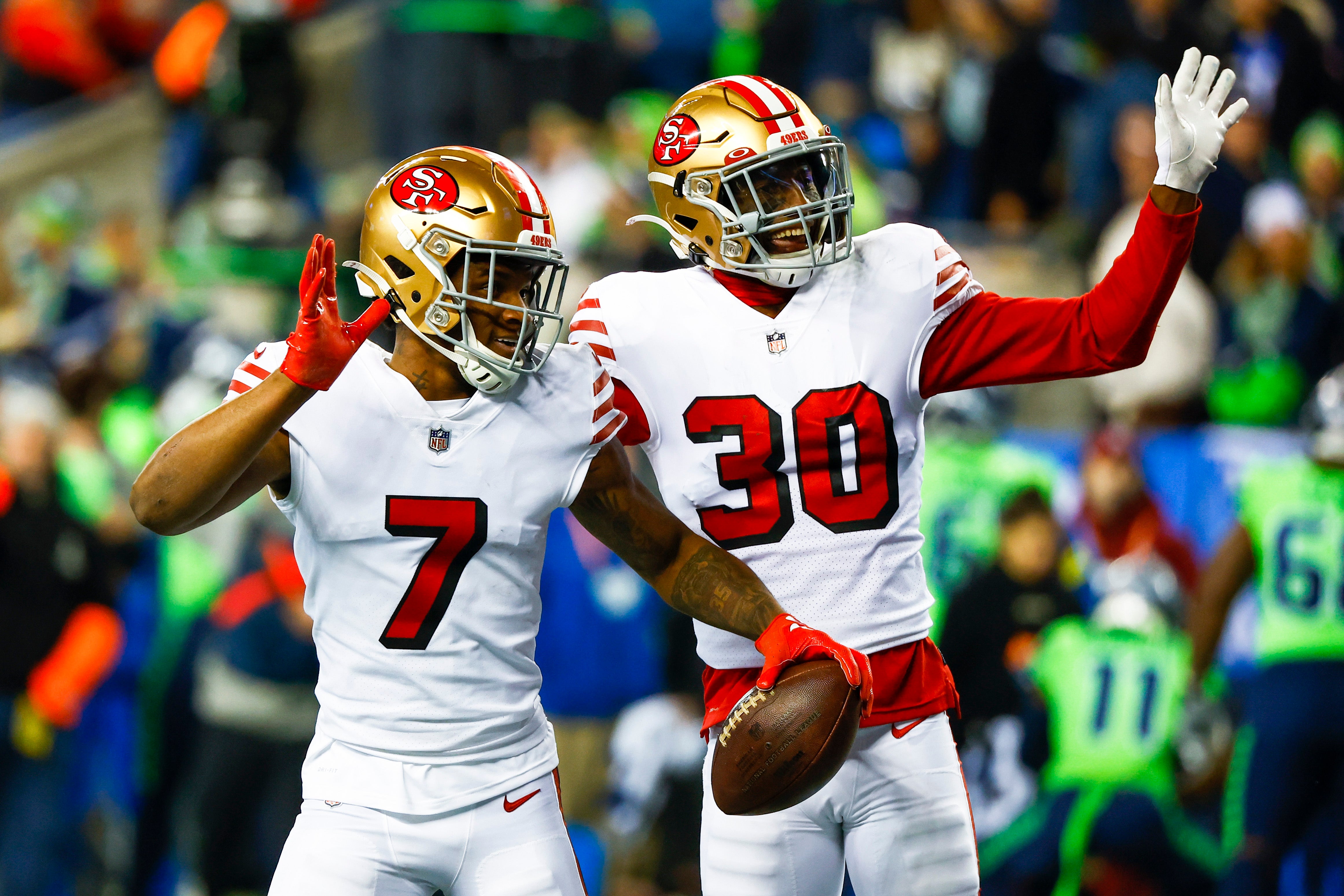 Dec 15, 2022; Seattle, Washington, USA; San Francisco 49ers cornerback Charvarius Ward (7) and safety George Odum (30) celebrate following a fumble return by Ward against the Seattle Seahawks during the second quarter at Lumen Field. Mandatory Credit: Joe Nicholson-USA TODAY Sports