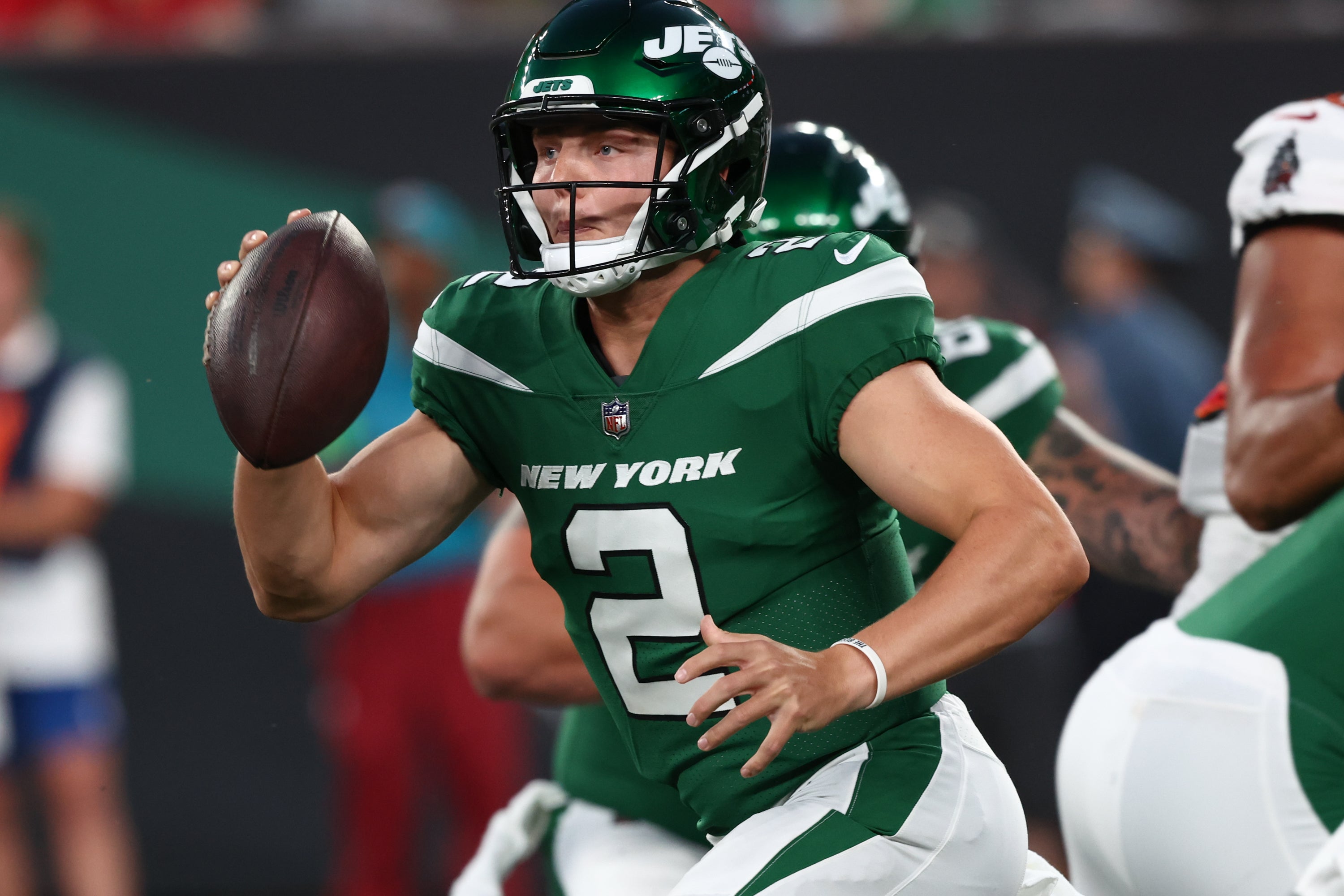 New York Jets quarterback Zach Wilson (2) runs with the ball against the Tampa Bay Buccaneers during the first half at MetLife Stadium.