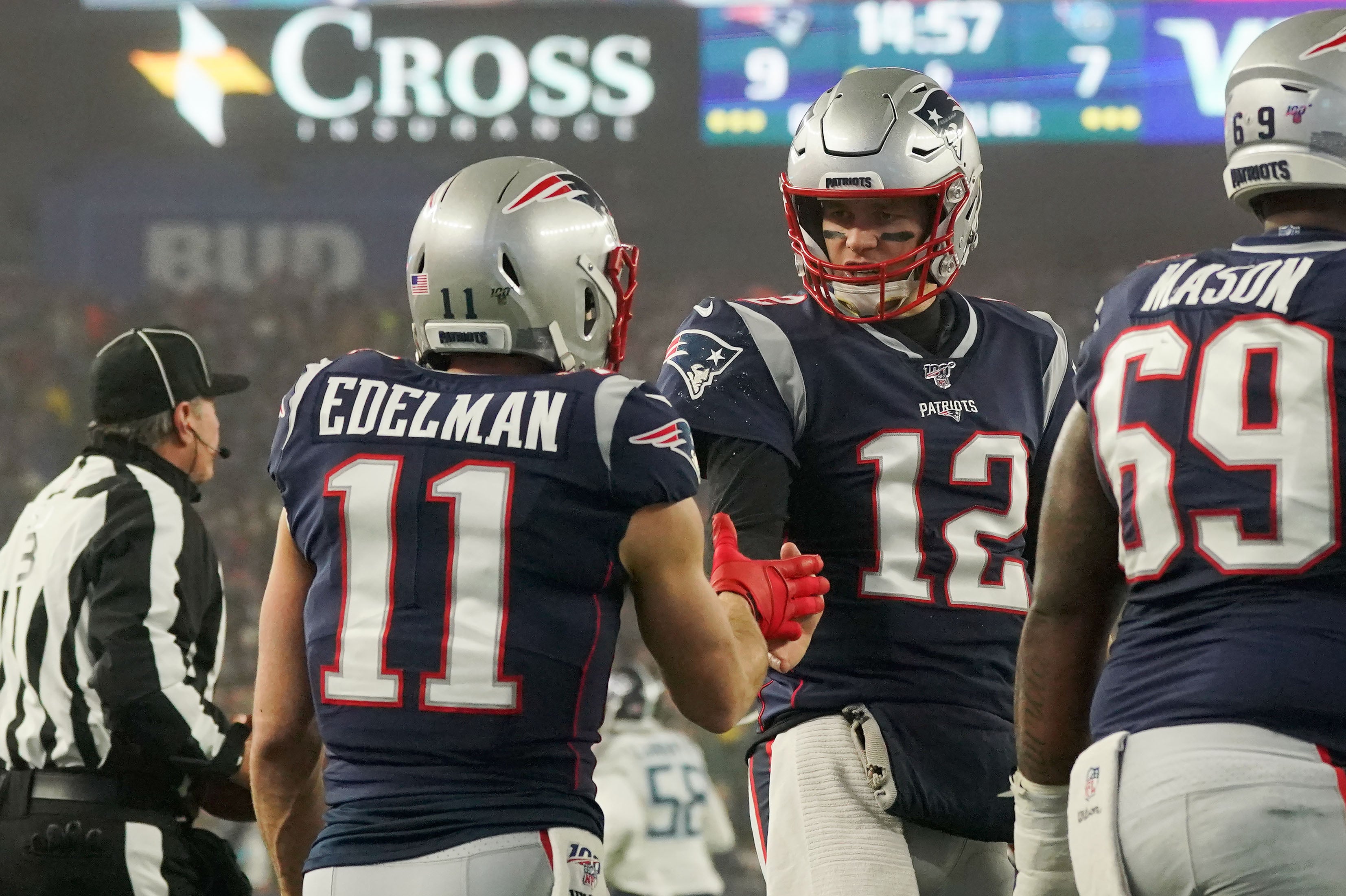 Jan 4, 2020; Foxborough, Massachusetts, USA; New England Patriots wide receiver Julian Edelman (11) high-fives quarterback Tom Brady (12) after scoring a touchdown against the Tennessee Titans during the second quarter at Gillette Stadium