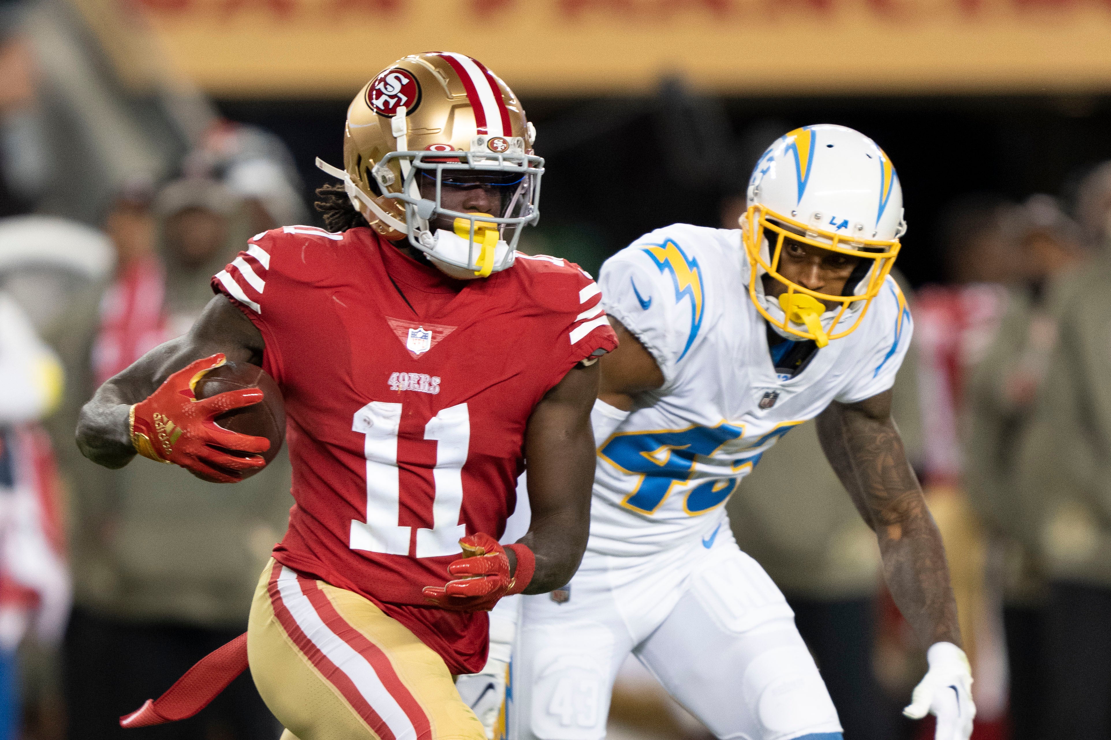 November 13, 2022; Santa Clara, California, USA; San Francisco 49ers wide receiver Brandon Aiyuk (11) runs against Los Angeles Chargers cornerback Michael Davis (43) during the second quarter at Levi's Stadium. Mandatory Credit: Kyle Terada-USA TODAY Sports
