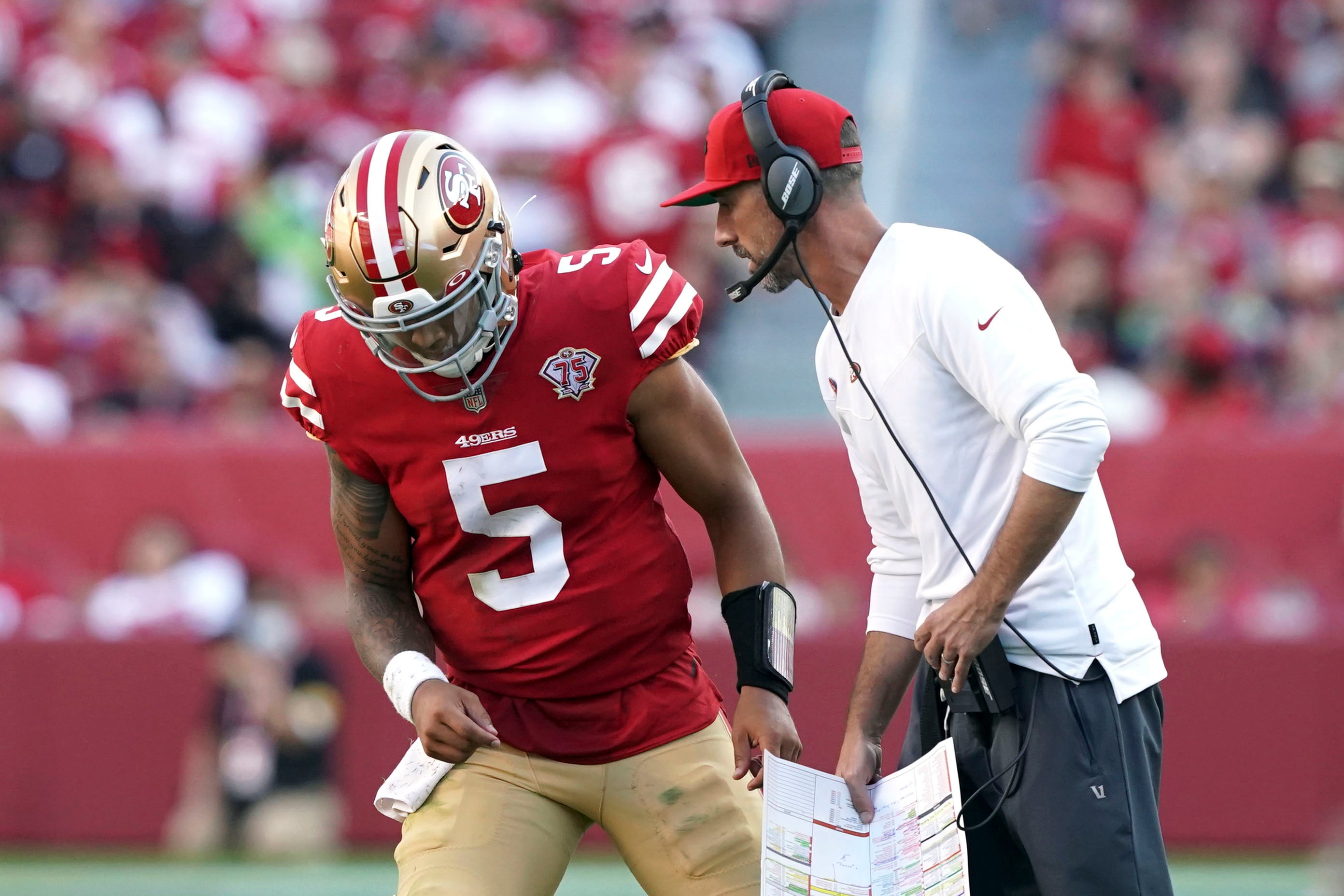 Oct 3, 2021; Santa Clara, California, USA; San Francisco 49ers head coach Kyle Shanahan talks to quarterback Trey Lance (5) during the fourth quarter against the Seattle Seahawks at Levi's Stadium. Mandatory Credit: Darren Yamashita-USA TODAY Sports
