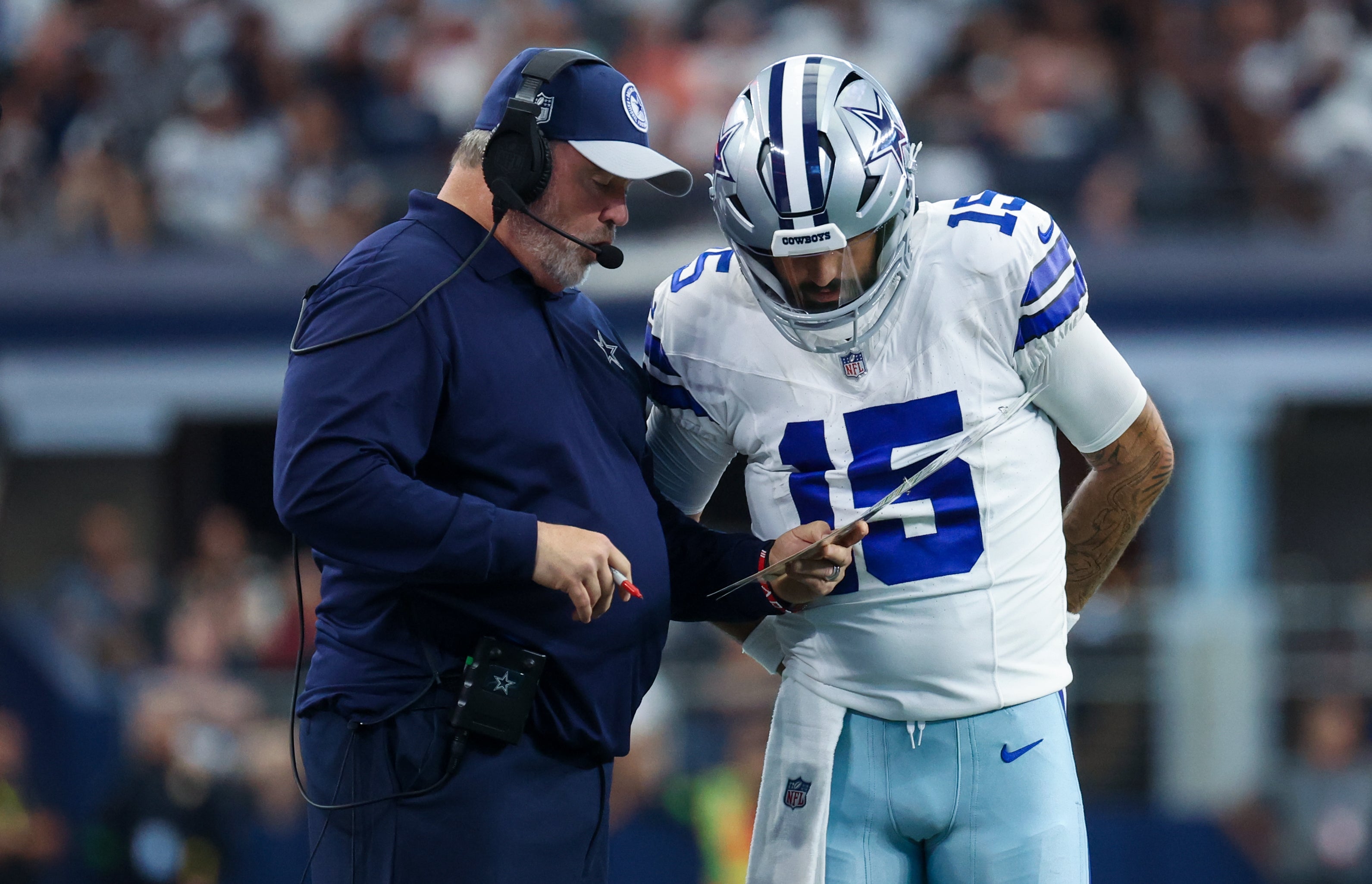 Dallas Cowboys head coach Mike McCarthy speaks with Dallas Cowboys quarterback Will Grier (15) during the second quarter against the Jacksonville Jaguars at AT&T Stadium. Mandatory Credit: Kevin Jairaj-USA TODAY Sports