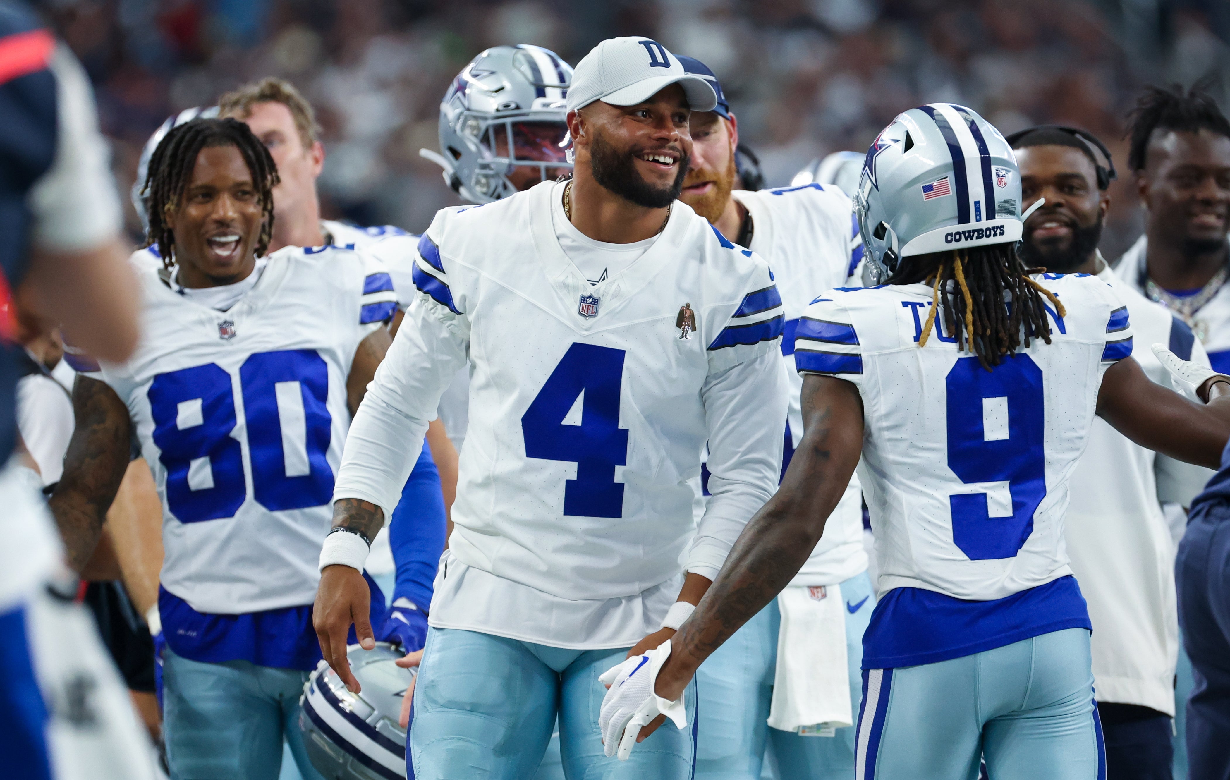 Dallas Cowboys quarterback Dak Prescott (4) laughs with teammates after a touchdown during the second quarter against the Jacksonville Jaguars at AT&T Stadium. Mandatory Credit: Kevin Jairaj-USA TODAY Sports