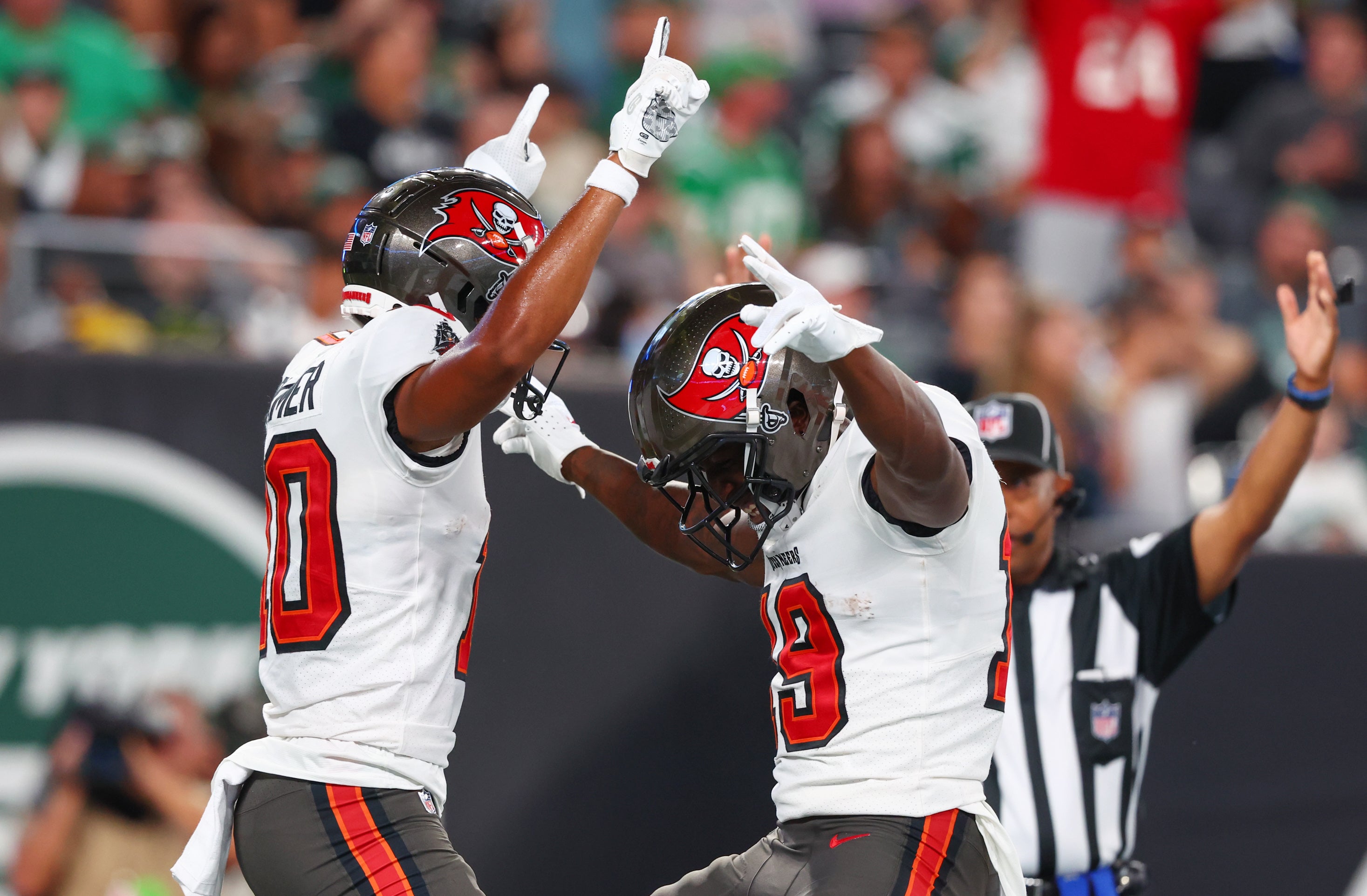 Aug 19, 2023; East Rutherford, New Jersey, USA; Tampa Bay Buccaneers wide receiver Trey Palmer (10) celebrates his touchdown against the New York Jets during the first half at MetLife Stadium. Mandatory Credit: Ed Mulholland-USA TODAY Sports