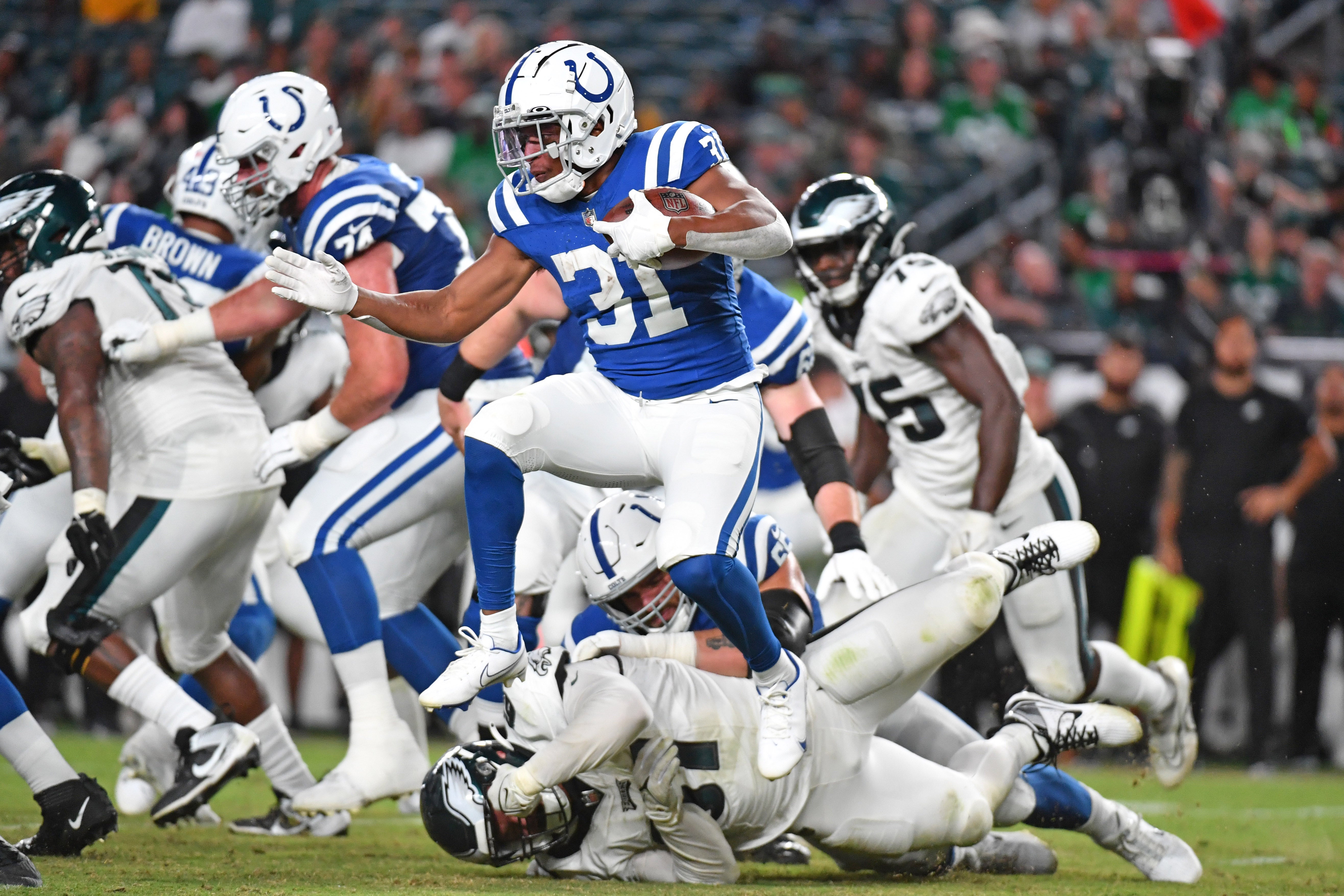 Aug 24, 2023; Philadelphia, Pennsylvania, USA; Indianapolis Colts running back Kenyan Drake (31) leaps over Philadelphia Eagles defensive tackle Caleb Sanders (67) during the fourth quarter at Lincoln Financial Field.