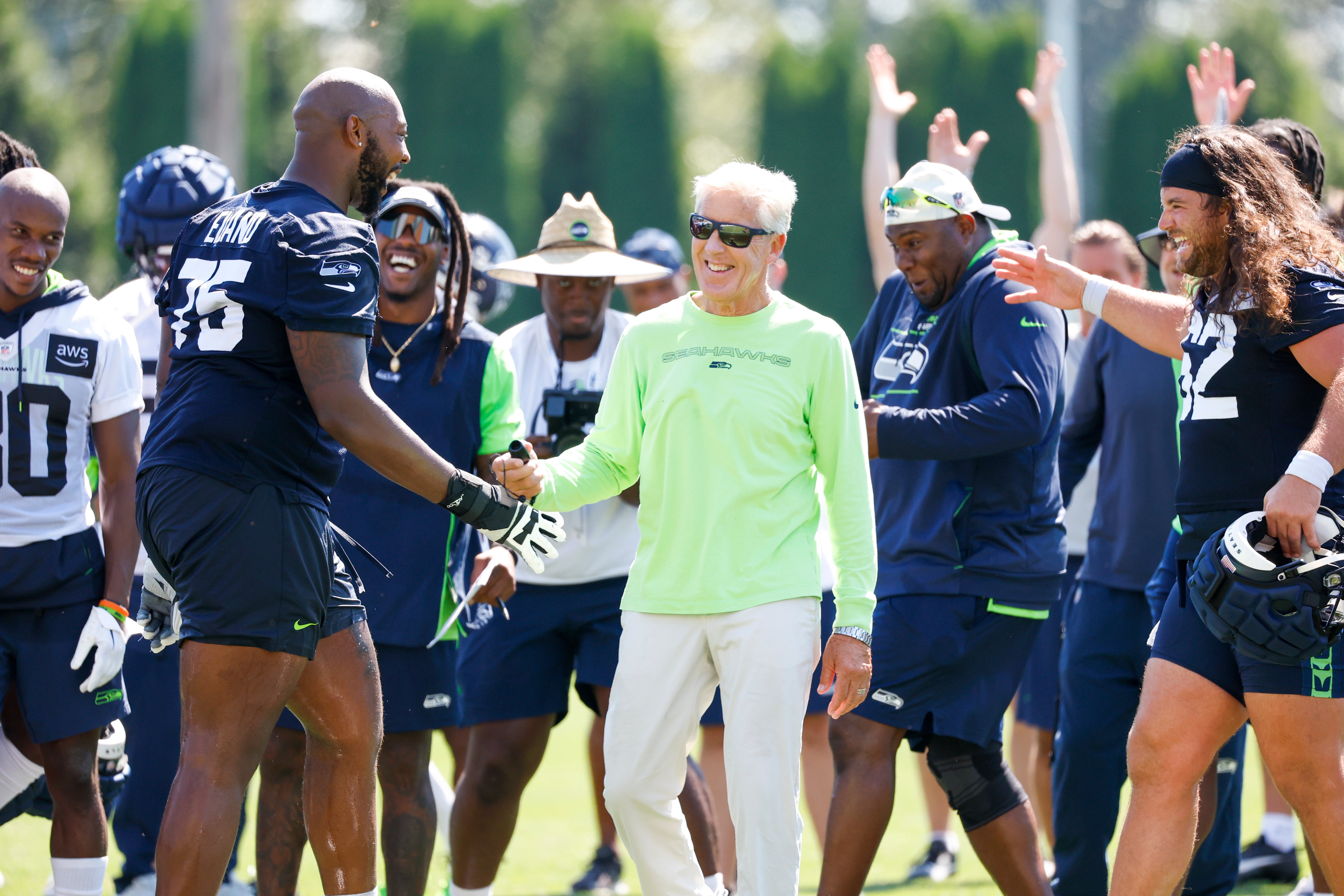 Jul 28, 2023; Renton, WA, USA; Seattle Seahawks offensive tackle Greg Eiland (75) celebrates with head coach Pete Carroll, middle, and center Joey Hunt (62, right) after kicking an extra point to end training camp practice at the Virginia Mason Athletic Center. Mandatory Credit: Joe Nicholson-USA TODAY Sports