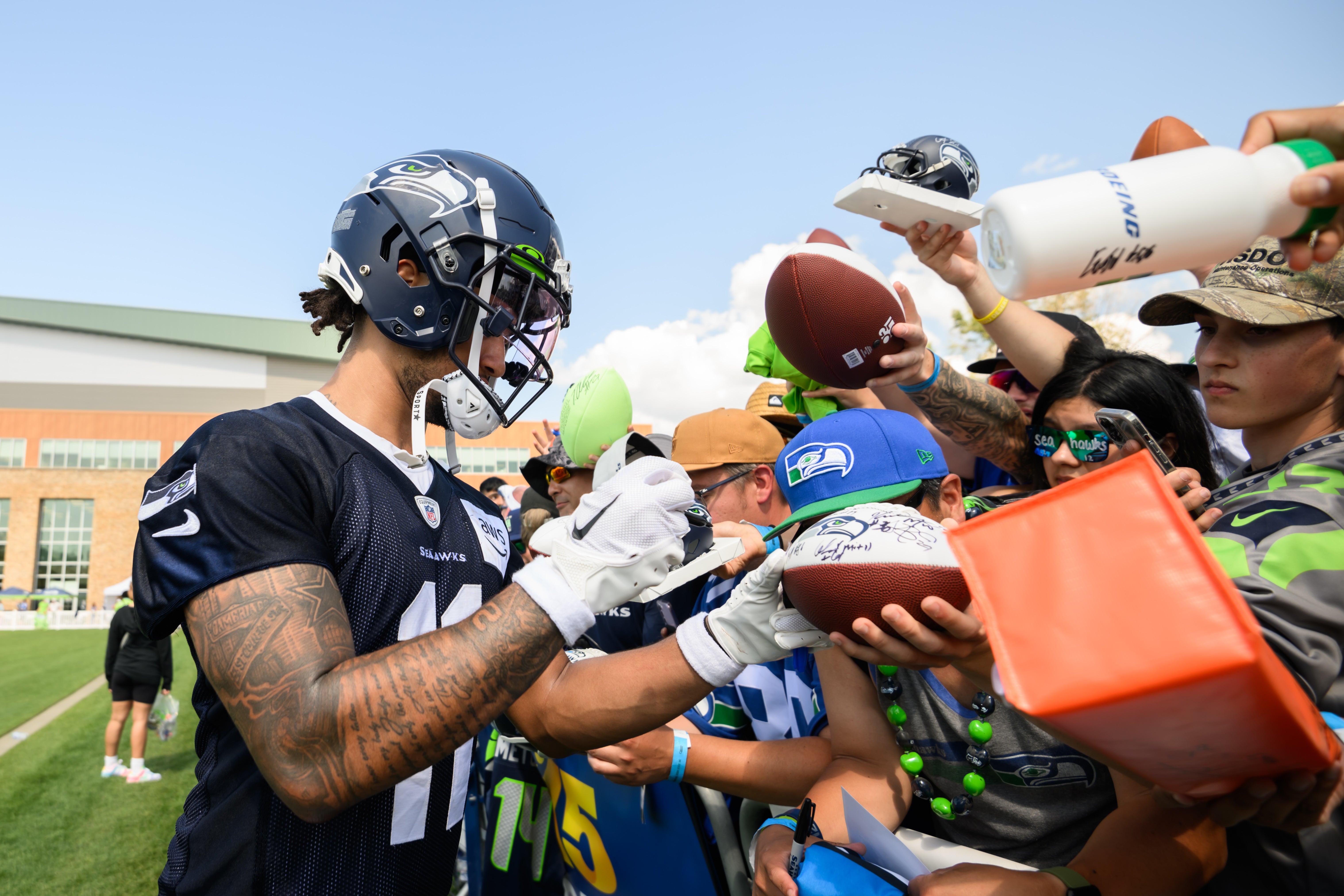 Jul 30, 2023; Renton, WA, USA; Seattle Seahawks wide receiver Jaxon Smith-Njigba (11) signs autographs after practice at the Virginia Mason Athletic Center. Mandatory Credit: Steven Bisig-USA TODAY Sports