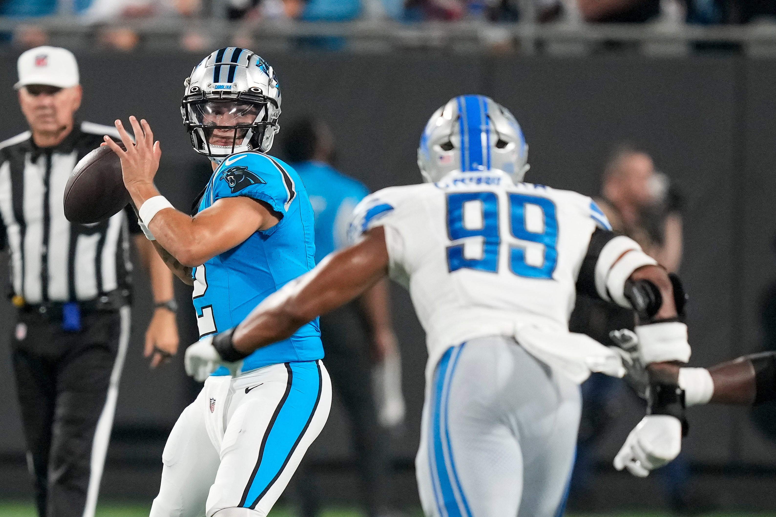 Aug 25, 2023; Charlotte, North Carolina, USA; Carolina Panthers quarterback Matt Corral (2) drops back to pass against Detroit Lions linebacker Julian Okwara (99) during the second half at Bank of America Stadium. Mandatory Credit: Jim Dedmon-USA TODAY Sports