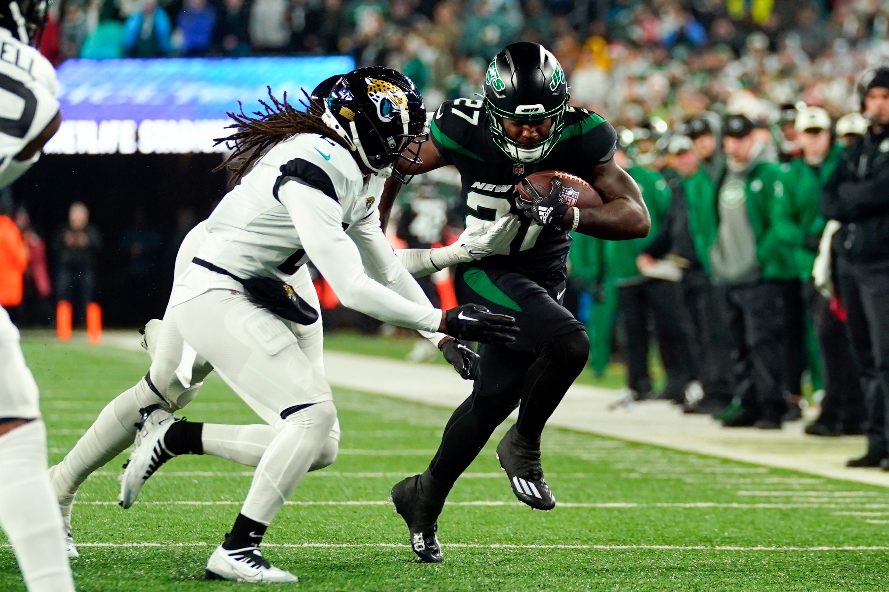 Dec 22, 2022; East Rutherford, New Jersey, USA; New York Jets running back Zonovan Knight (27) rushes against the Jacksonville Jaguars in the first half at MetLife Stadium.
