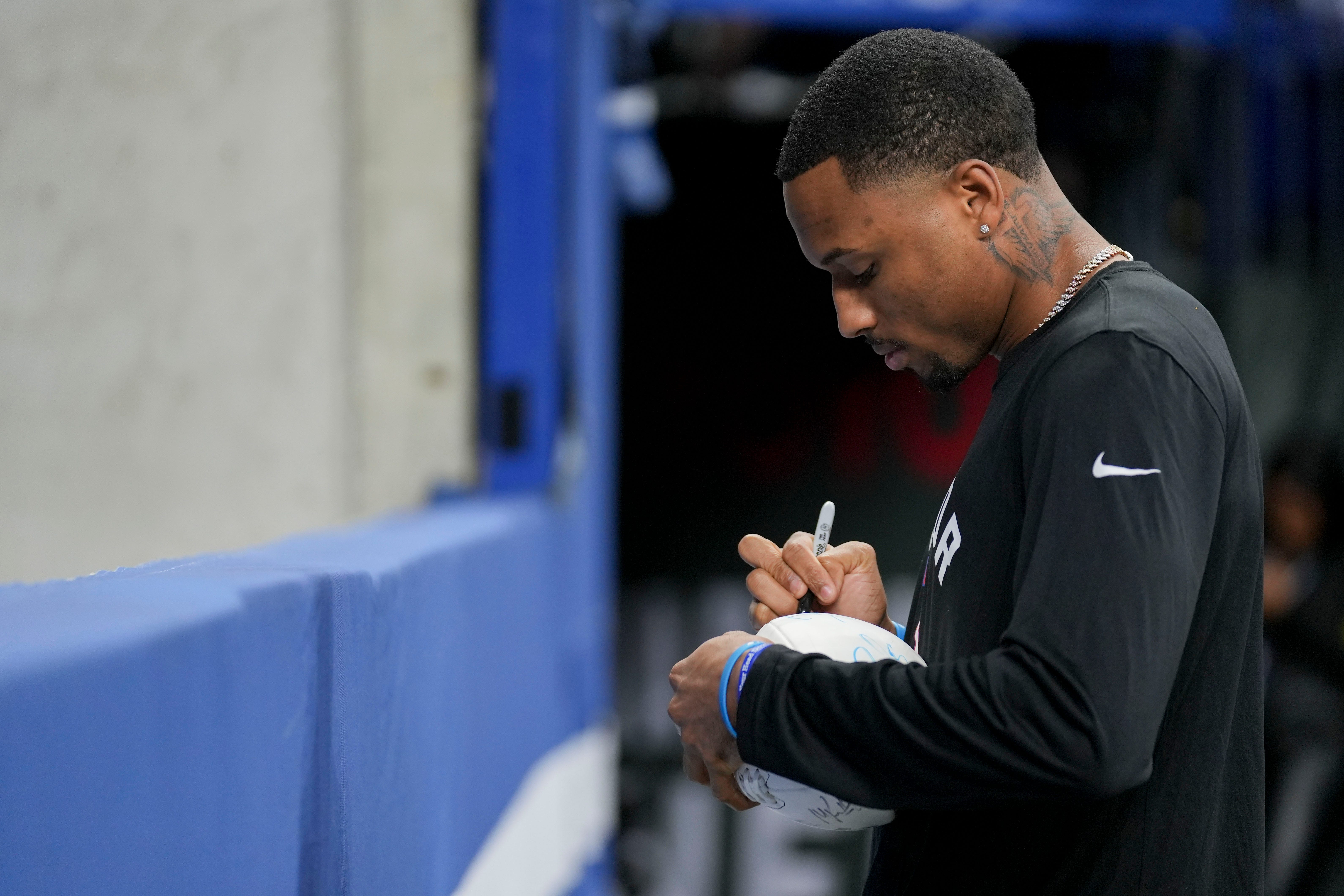 Indianapolis Colts cornerback Isaiah Rodgers Sr. (34) signs a ball for a fan Sunday, Jan. 8, 2023, during a game against the Houston Texans at Lucas Oil Stadium in Indianapolis.