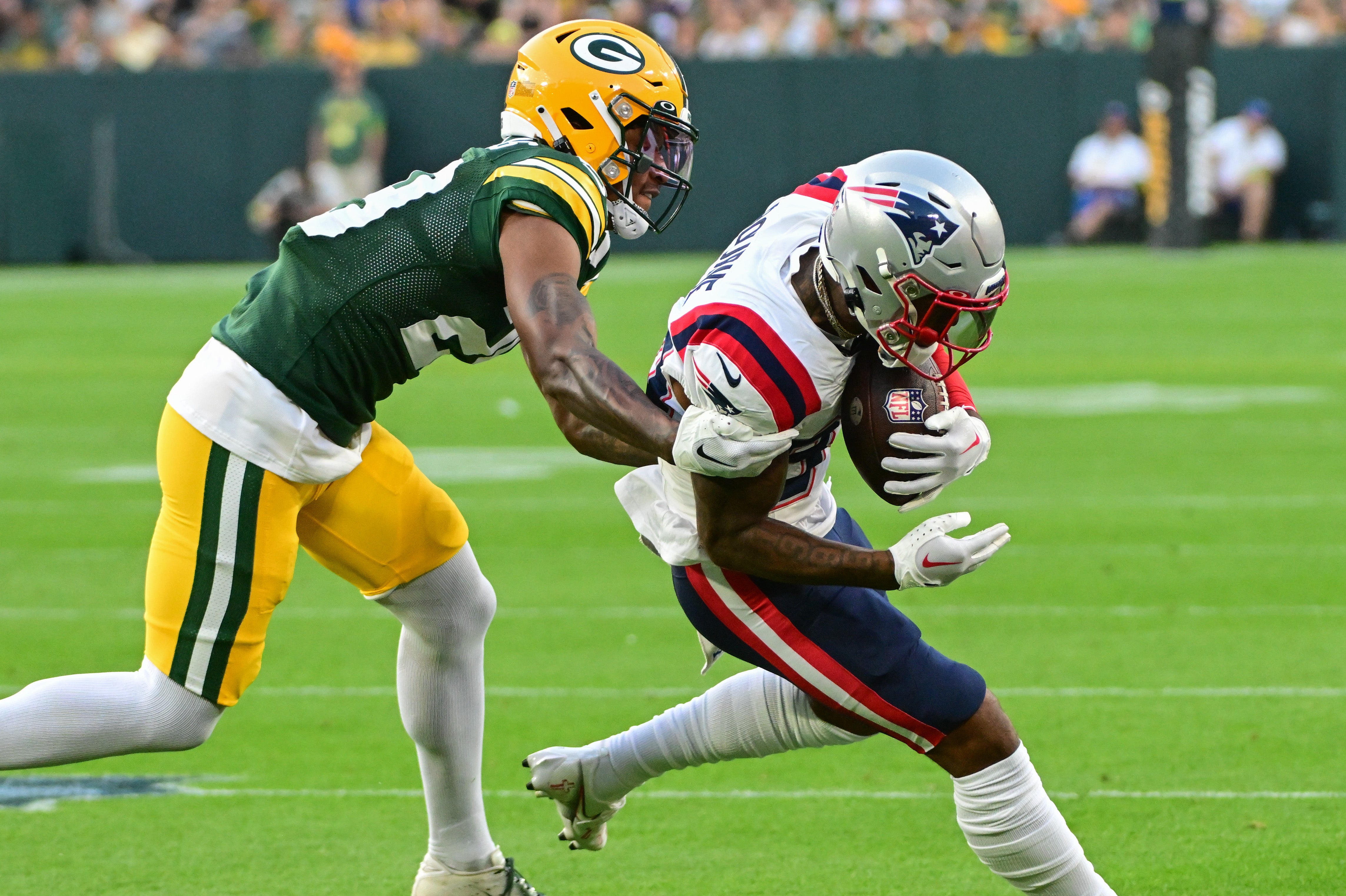 Aug 19, 2023; Green Bay, Wisconsin, USA; New England Patriots wide receiver Kendrick Bourne (84) catches a pass against Green Bay Packers corner back Rasul Douglas (29) in the first quarter at Lambeau Field