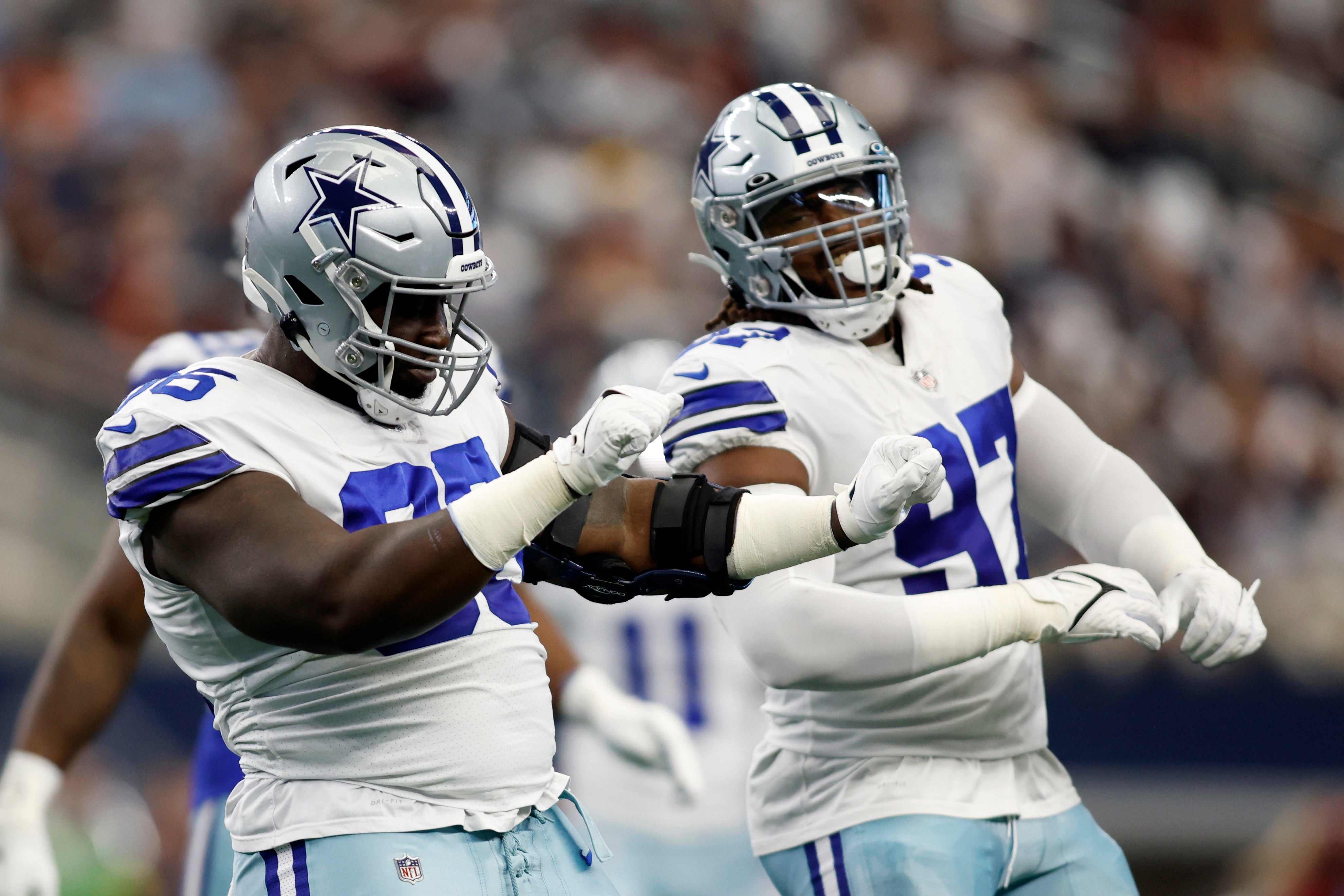 Dallas Cowboys defensive tackle Neville Gallimore (96) and defensive tackle Osa Odighizuwa (97) celebrate a sack in the first quarter against the Washington Commanders at AT&T Stadium. Mandatory Credit: Tim Heitman-USA TODAY Sports